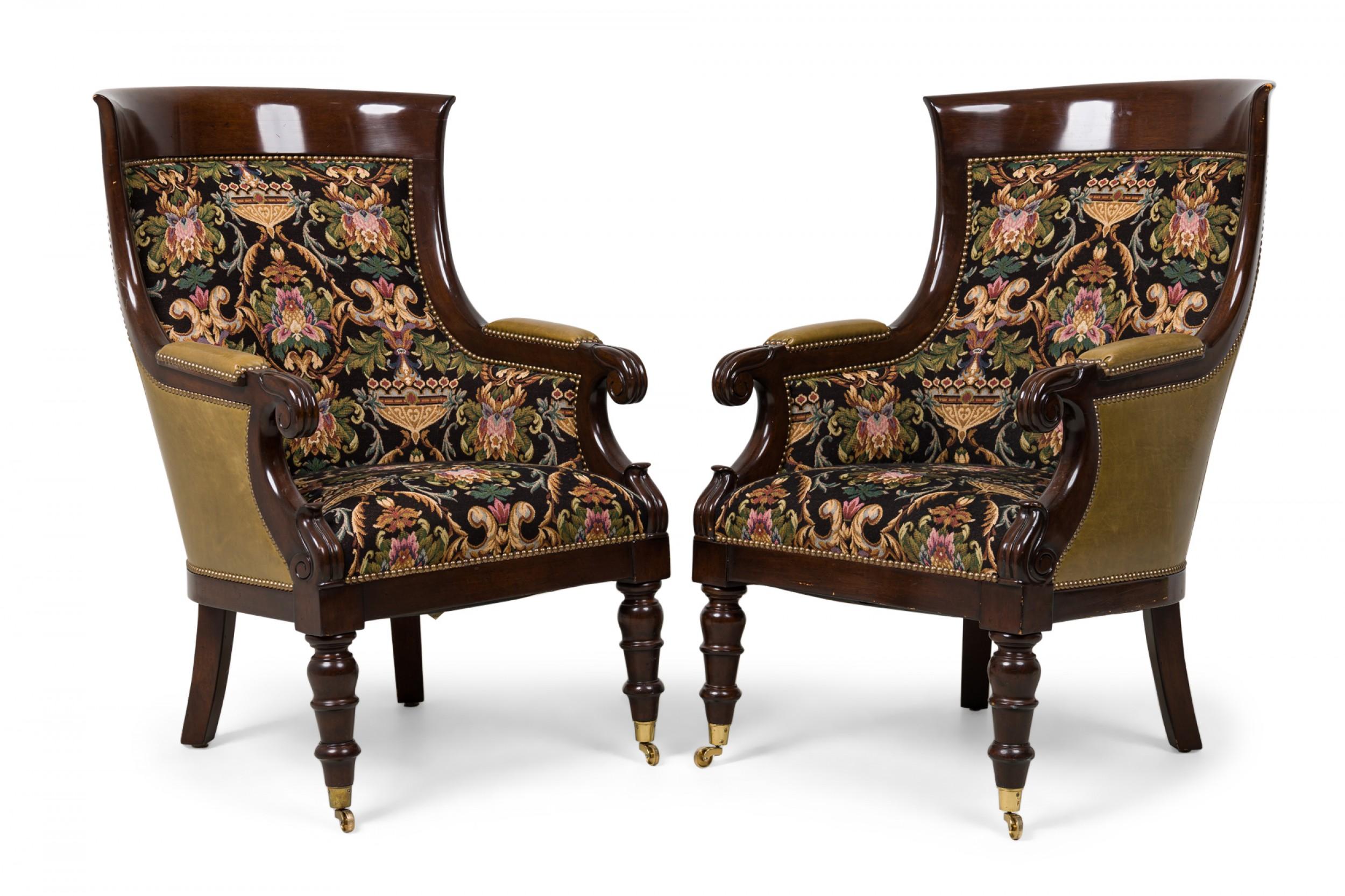 Pair of English Regency Style (20th Century) bergeres with curved mahogany frames, scroll arms, leather upholstered backs and armrests, the front and seat upholstered in an urn-themed scroll & foliate tapestry bordered by brass nailhead trim,