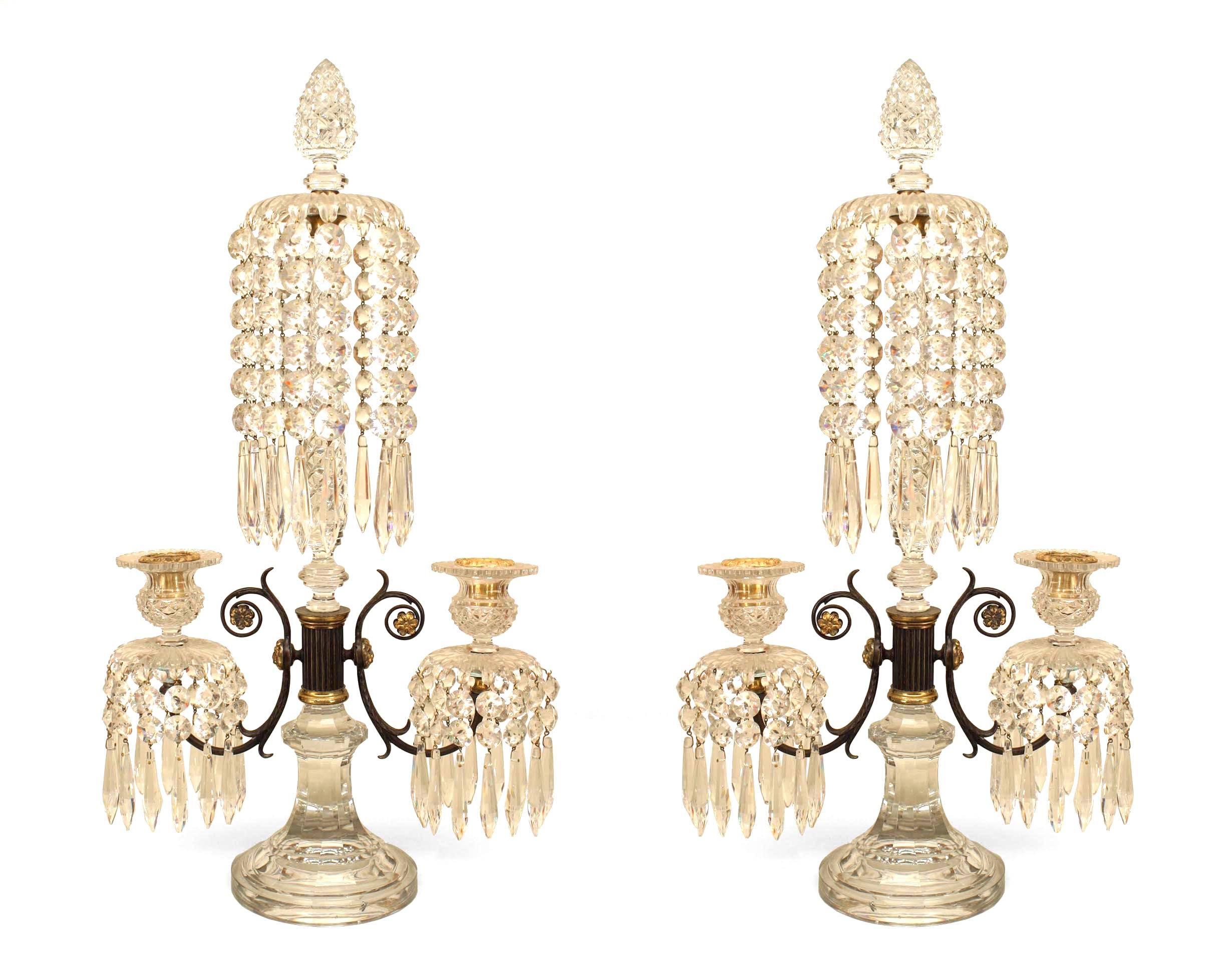 Pair of English Regency Waterford candelabras with a pine cone finial above a swirl center post and 2 arms emanating from a metal and brass centerpost having crystal drops (PRICED AS Pair)
