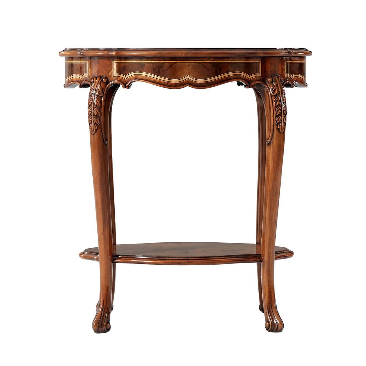 A figured walnut and mahogany banded accent table with inlaid and crossbanded details, the serpentine molded edge oval top above a shaped frieze on finely acanthus carved cabriole legs joined by a serpentine oval shelf stretcher.

Dimensions: 24