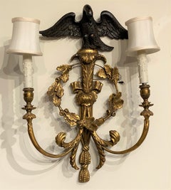 Pair of English Rococo Style Giltwood Two Light Sconces with Ebonized Eagle Tops