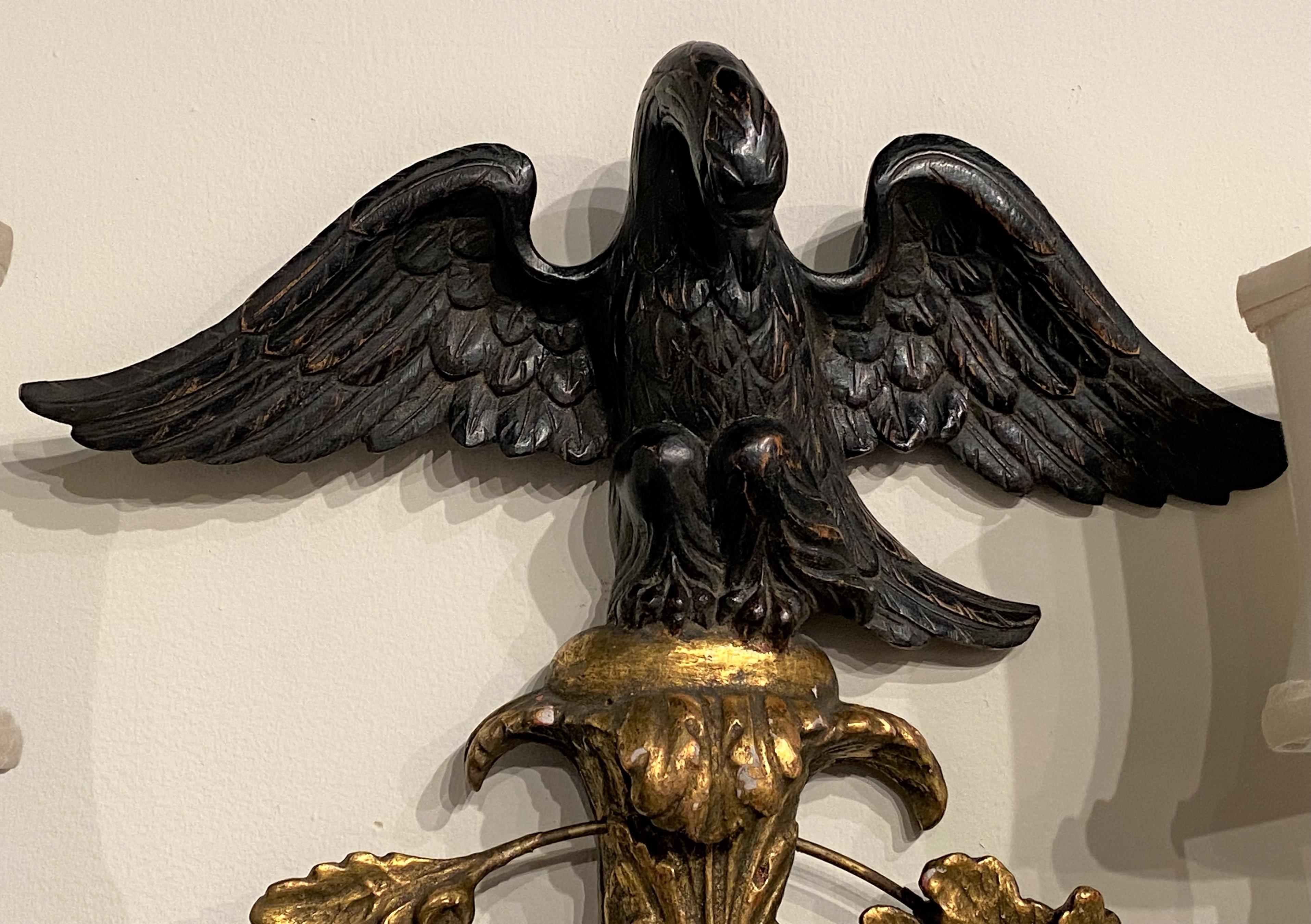 20th Century Pair of English Rococo Style Giltwood Two Light Sconces with Ebonized Eagle Tops For Sale