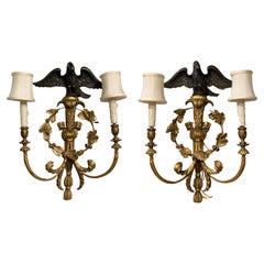Pair of English Rococo Style Giltwood Two Light Sconces with Ebonised Eagle Tops