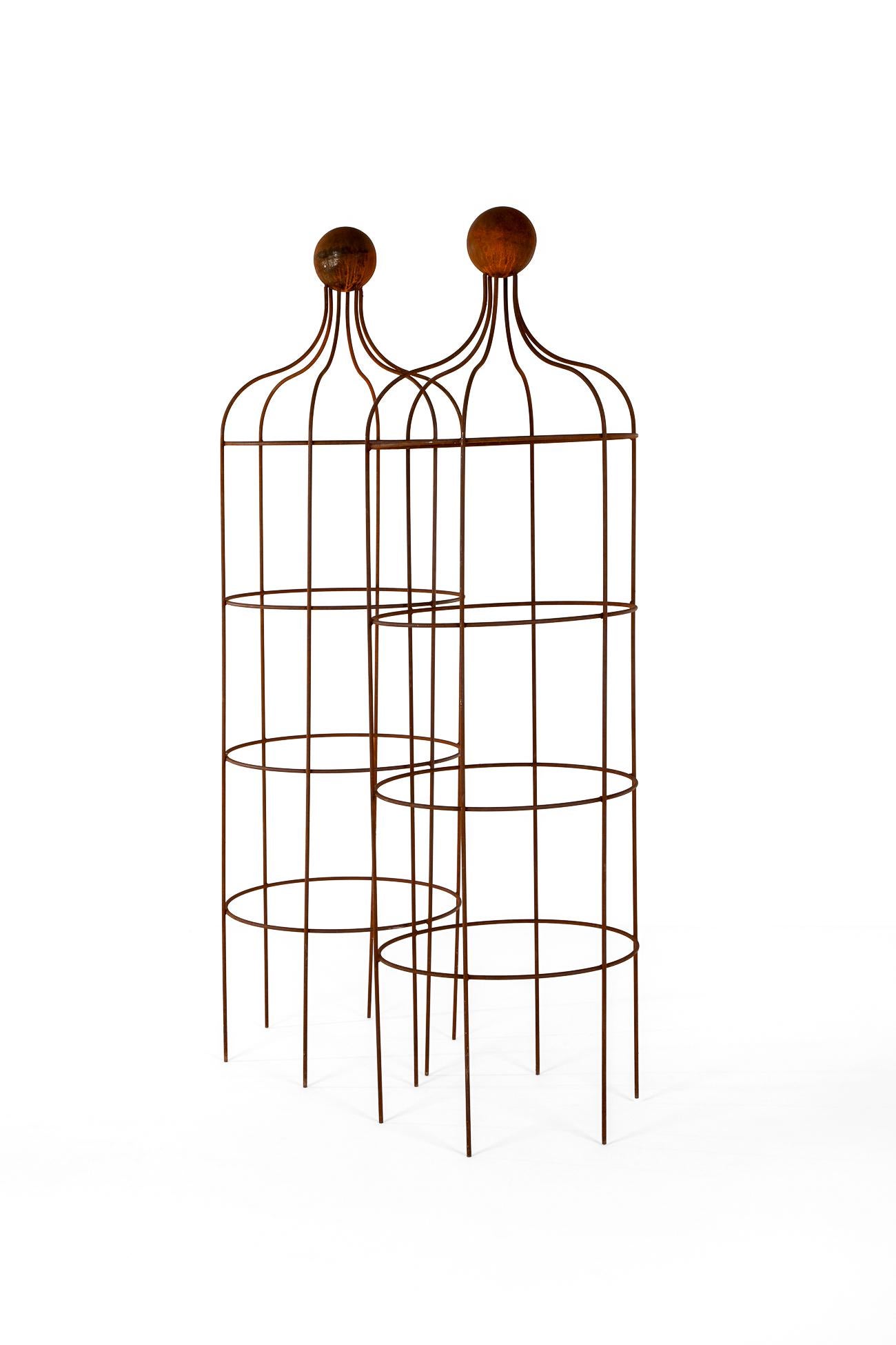 A commanding pair of hand forged wrought iron garden obelisk.

Cylindrical in form with with the top having a curved outline with a ball finial.

This pair was salvaged from the rose gardens from  a north Yorkshire estate.

Price is for the