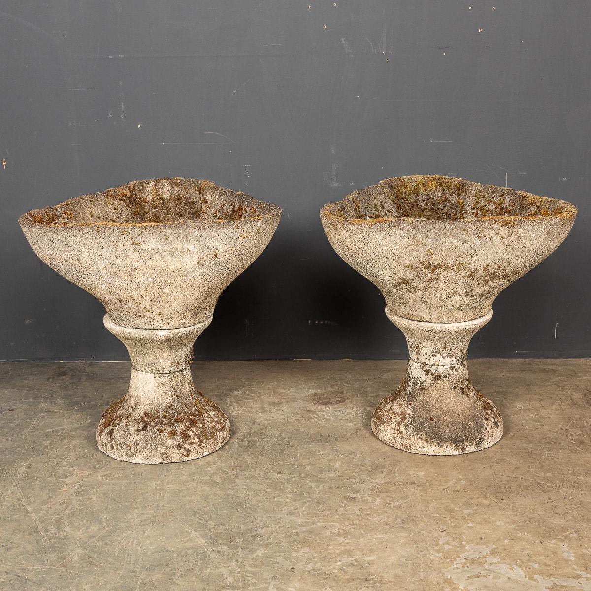 A large pair of stone garden urns in a scalloped bowl shape. This pair have a natural patina and look amazing with or without plants. These urns are in good condition, their age only contributing to their inherent character and allure.

We offer