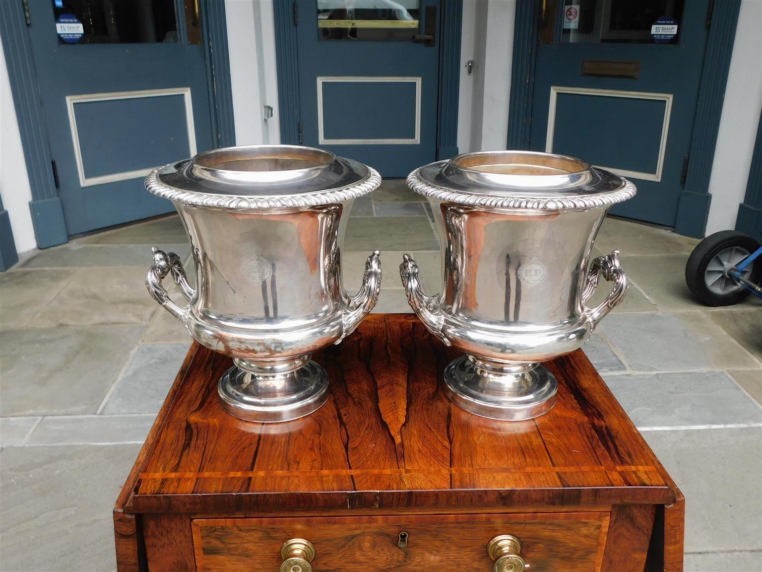 Pair of English Sheffield engraved urn form champagne buckets with gadrooned molded rims, removable interior liners, flanking acanthus side handles, and resting on step back molded edge bases, Early 19th century. Stamped by makers hallmarks double