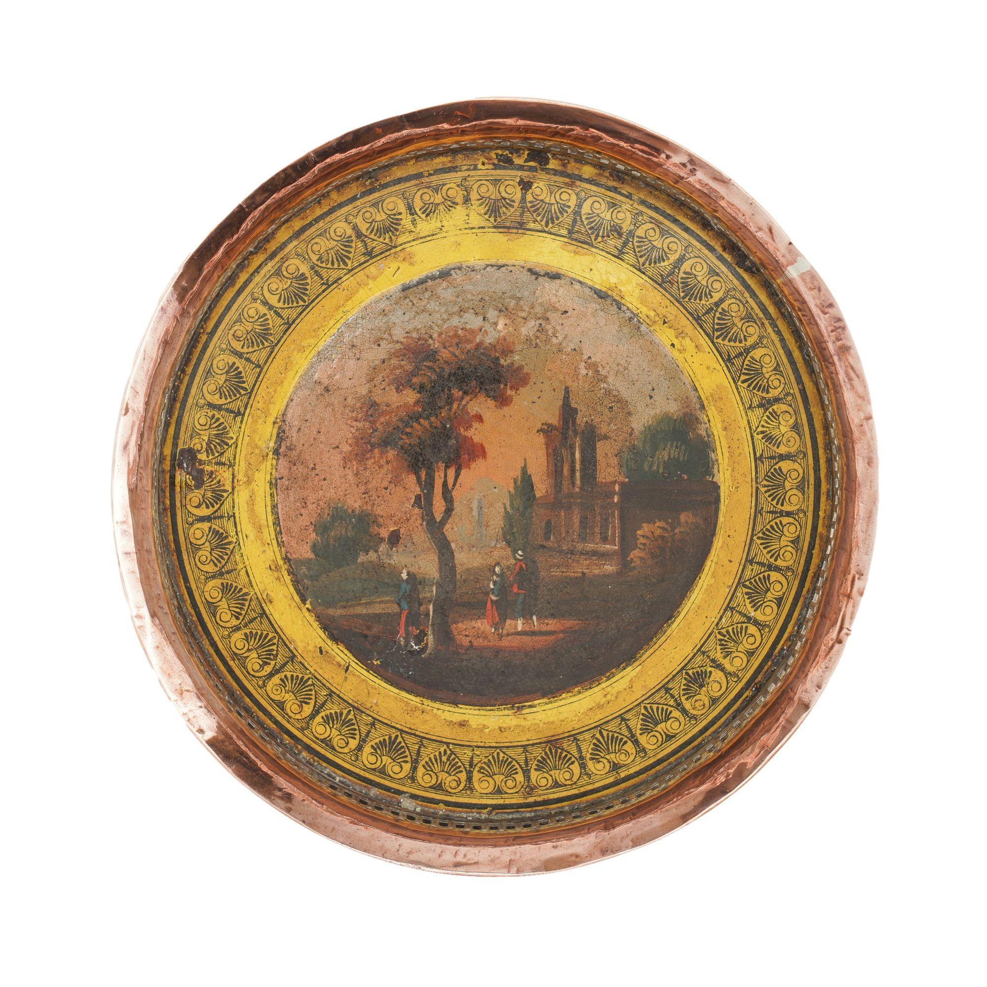 Pair of silver plated copper bottle coasters with a yellow enamel painted interior and printed anthemion border centering on painted landscapes of gothic ruins. The finely reticulated galleries are copper with traces of silvering. 
England, circa