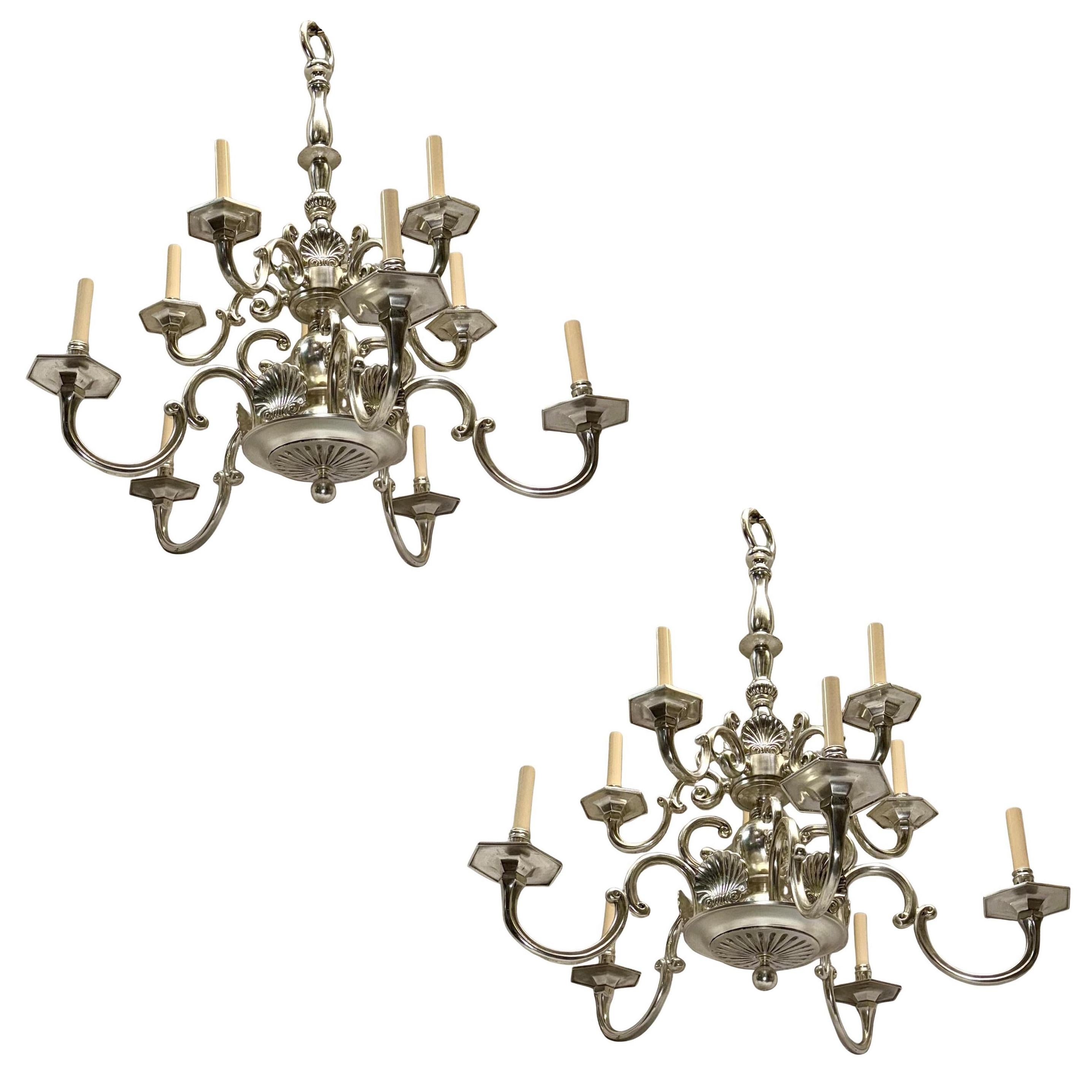 Pair of 1930's silver plated chandeliers with shell motif and 9 candelabra lights.
Sold and priced individually.

Measurements:
Height: 37