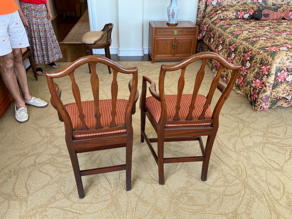 Pair of antique English shield back mahogany armchairs hand carved upholstered seats and having 