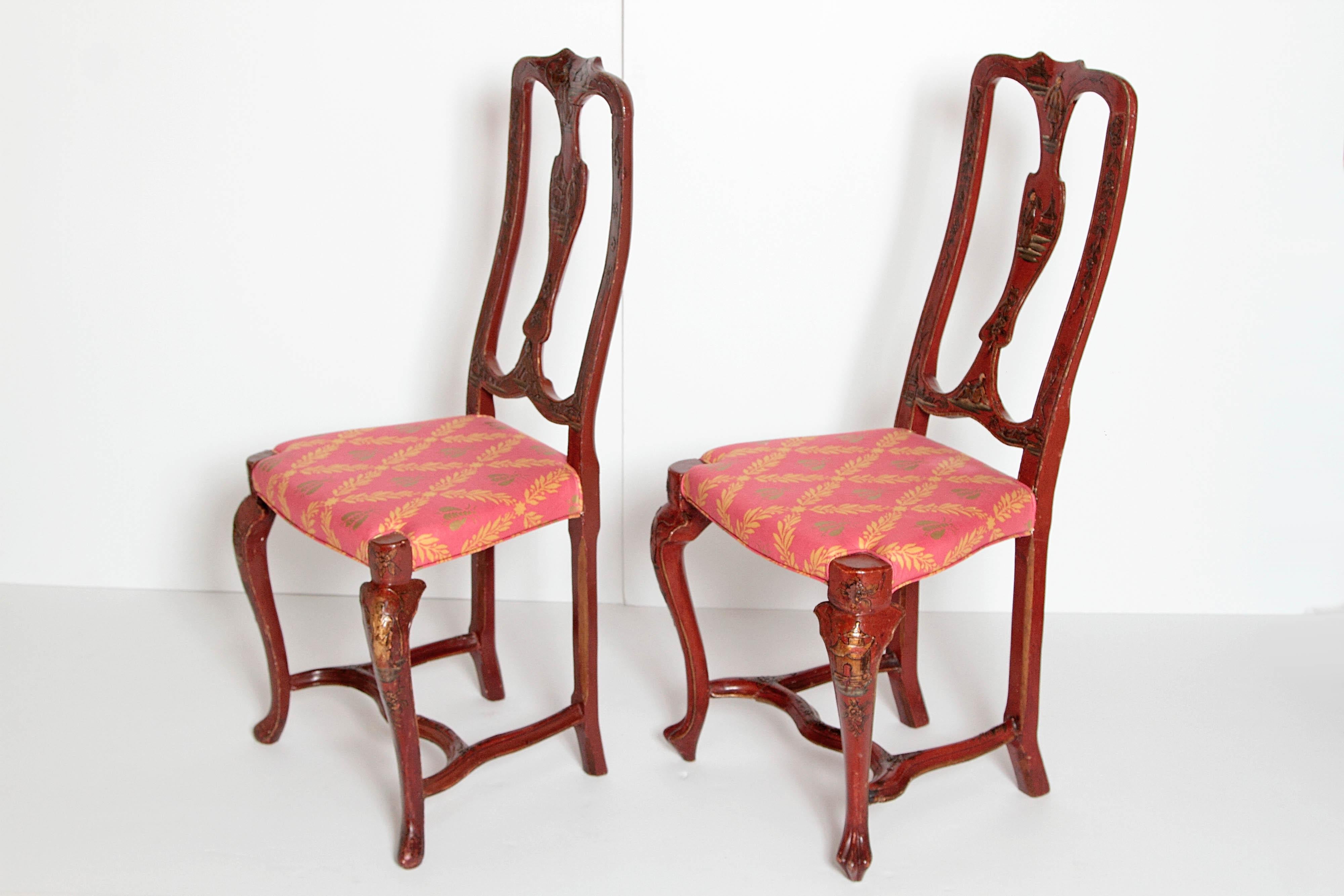 A pair of Queen Anne style carved and painted side chairs with upholstered seat. Chinoiserie decoration on back, cabriole legs and stretcher.