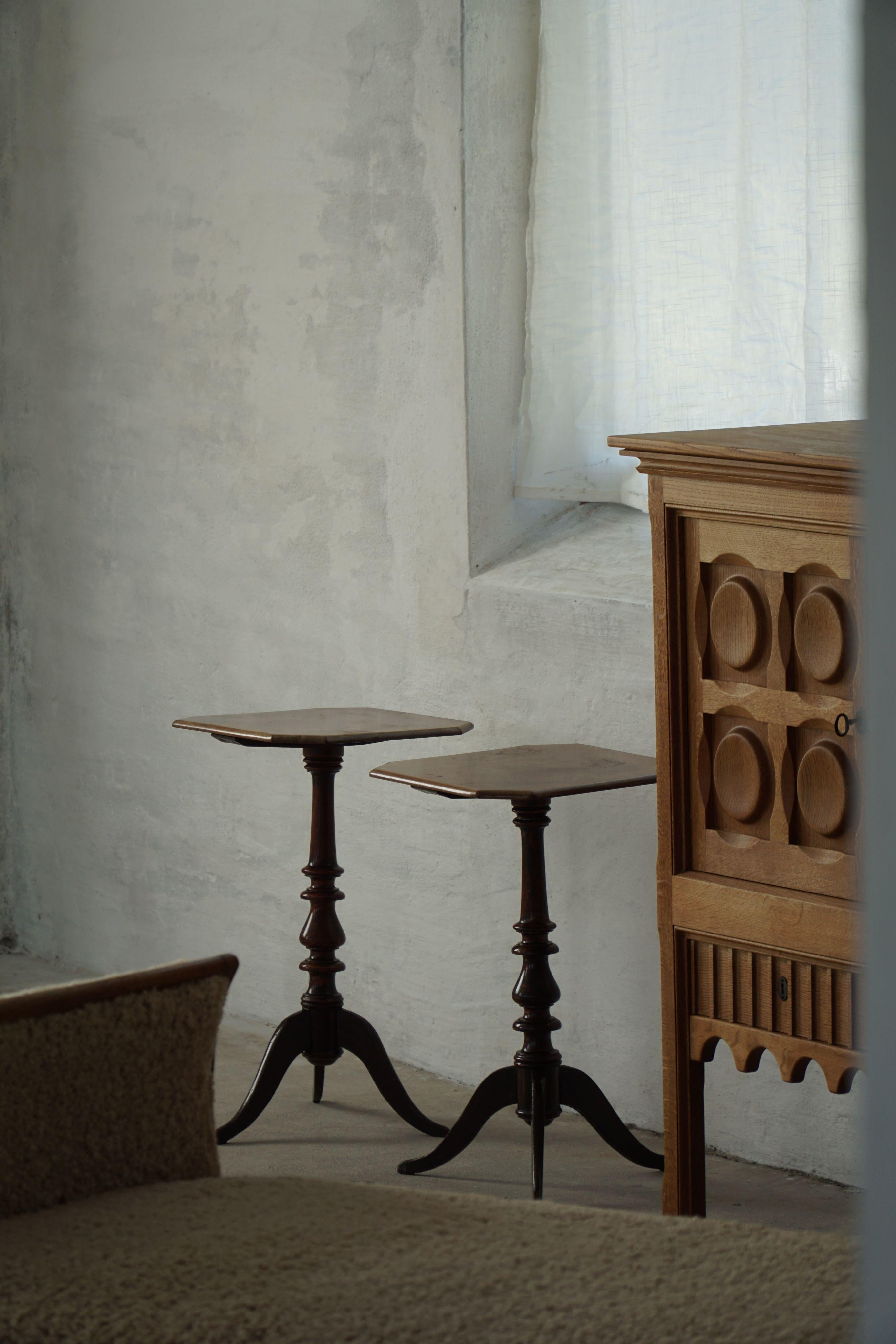 A remarkable pair of British mid-20th-century side or drinks tables, meticulously crafted from nutwood with octagonal-shaped tabletops. The design has a balanced geometry that is both elegant and versatile in use. The tops are smooth and inviting,