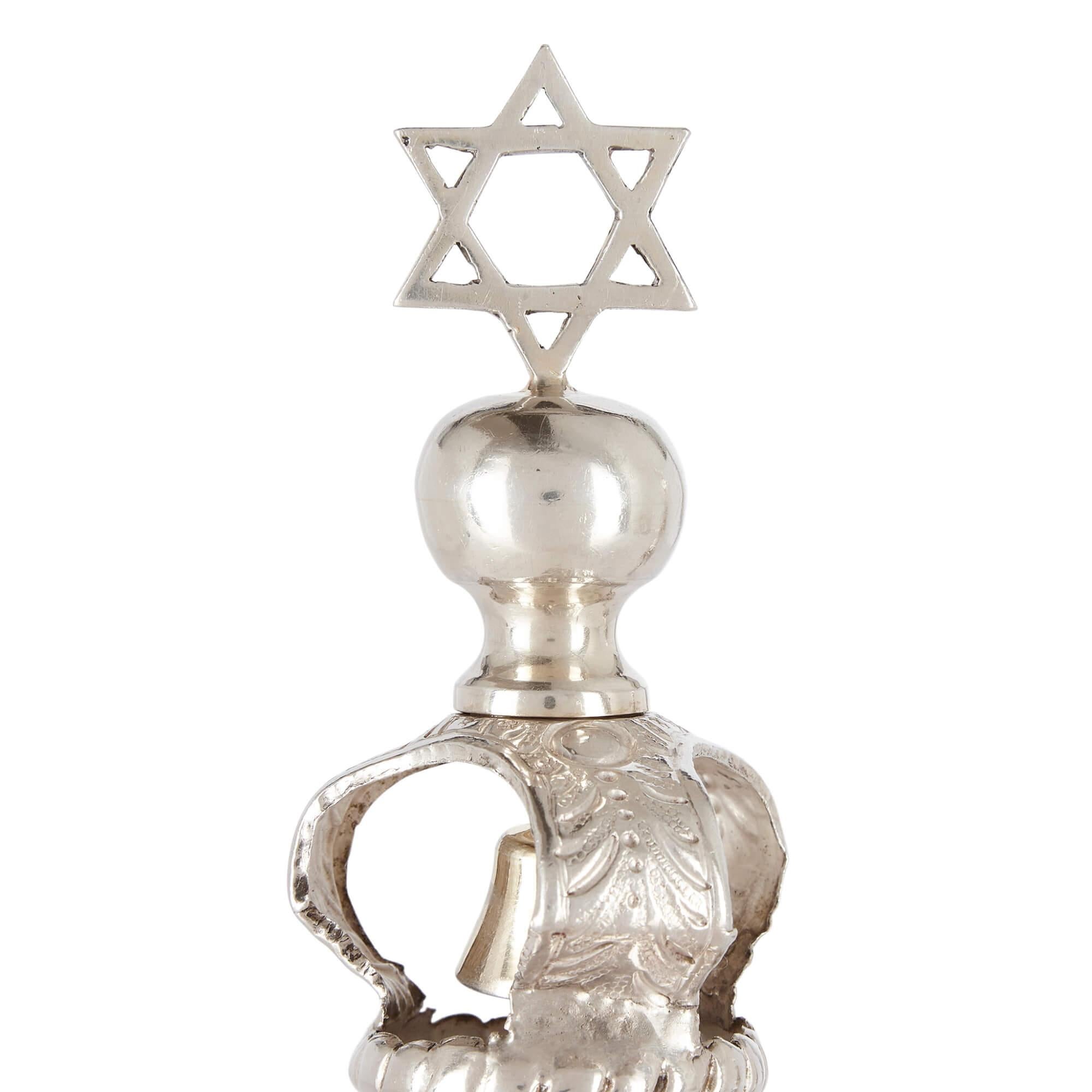 Pair of English silver and silver gilt rimonim 
English, c. 1920
Height 37cm, diameter 10cm

Forged from luminous silver and enhanced with elegant silver gilt accents, this refined pair of antique Judaica, referred to as Rimonim, function as Torah