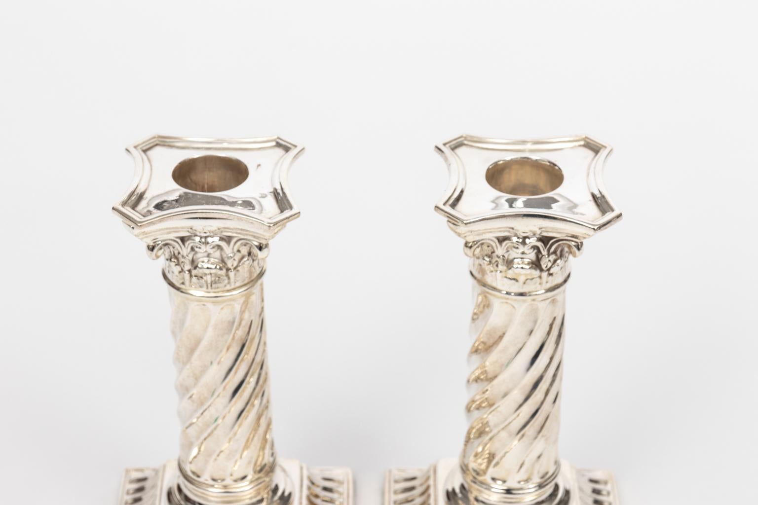 Pair of English silver plate classical Corinthian style column candlesticks, circa 1930s. Please note of wear consistent with age. Made in England.