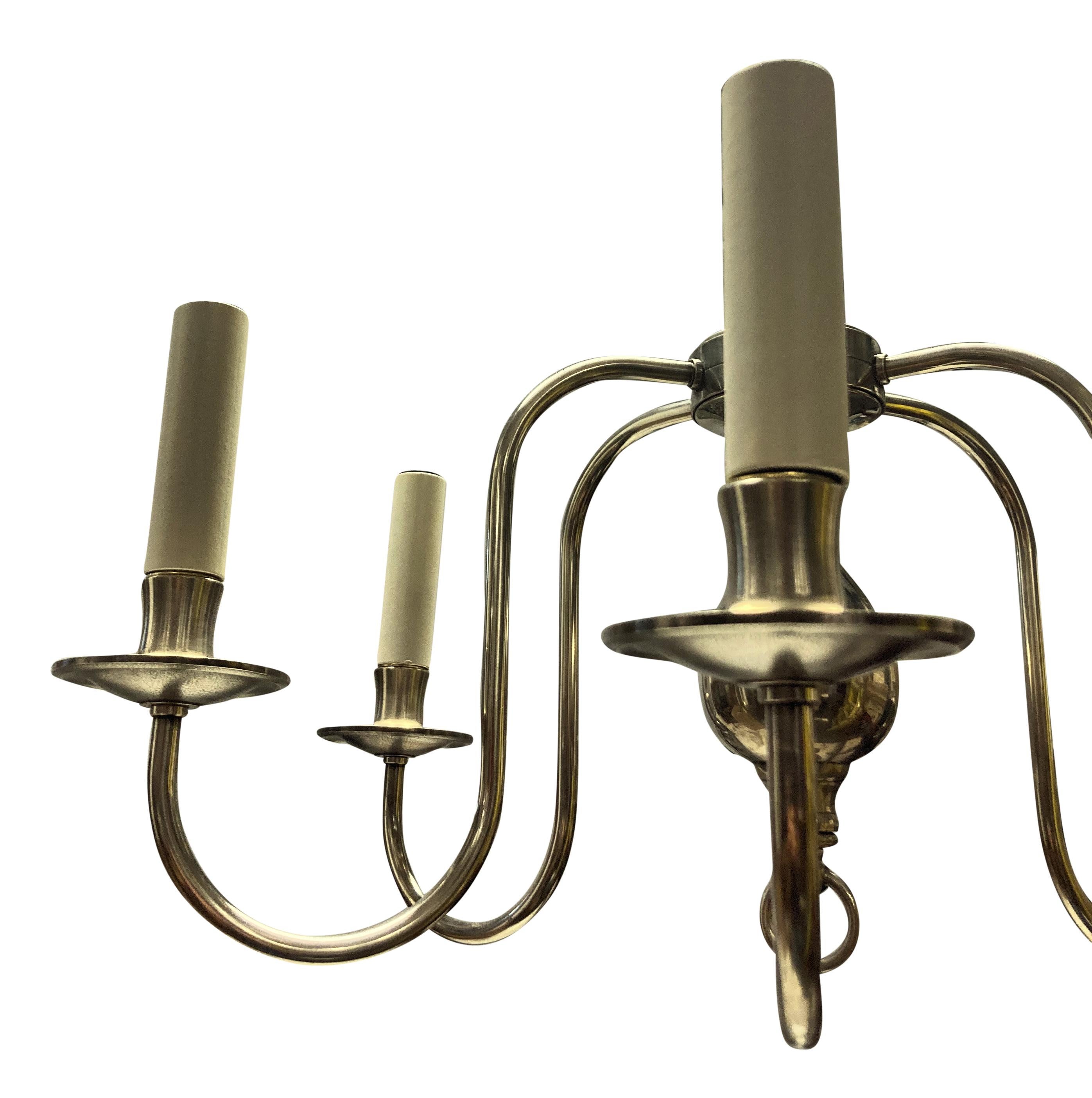 A pair of English silver plated six branch chandeliers, of simple linear design.