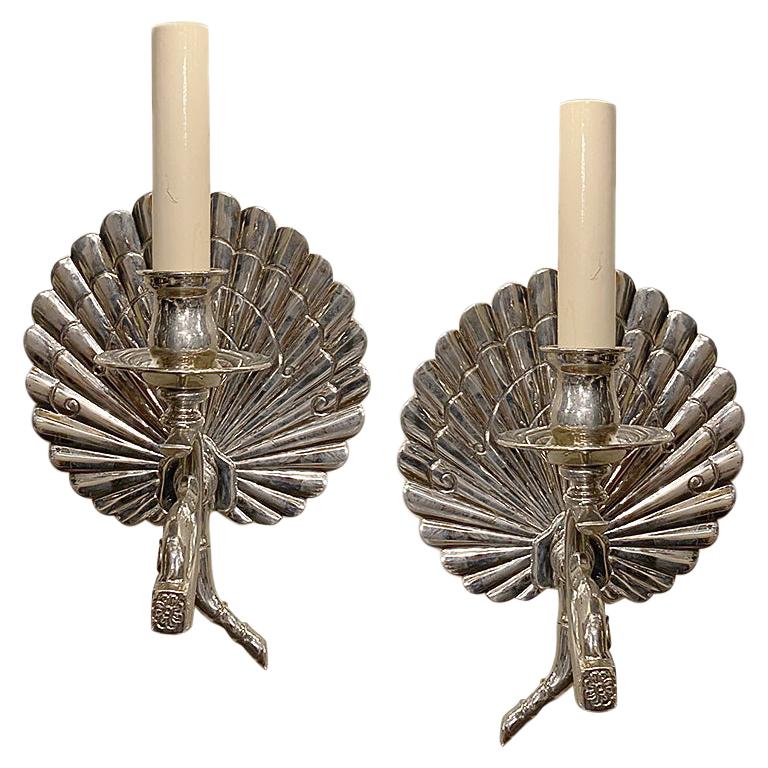 A pair of circa 1920's English silver plated single light sconces with fan-shaped backplate and branch motif.

Measurements:
Height: 9
