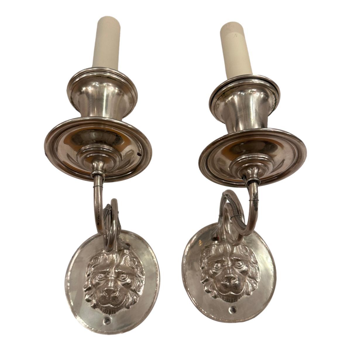 Pair of circa 1940's English silver-plated sconces with lion head motif.

Measurements:
Height: 10