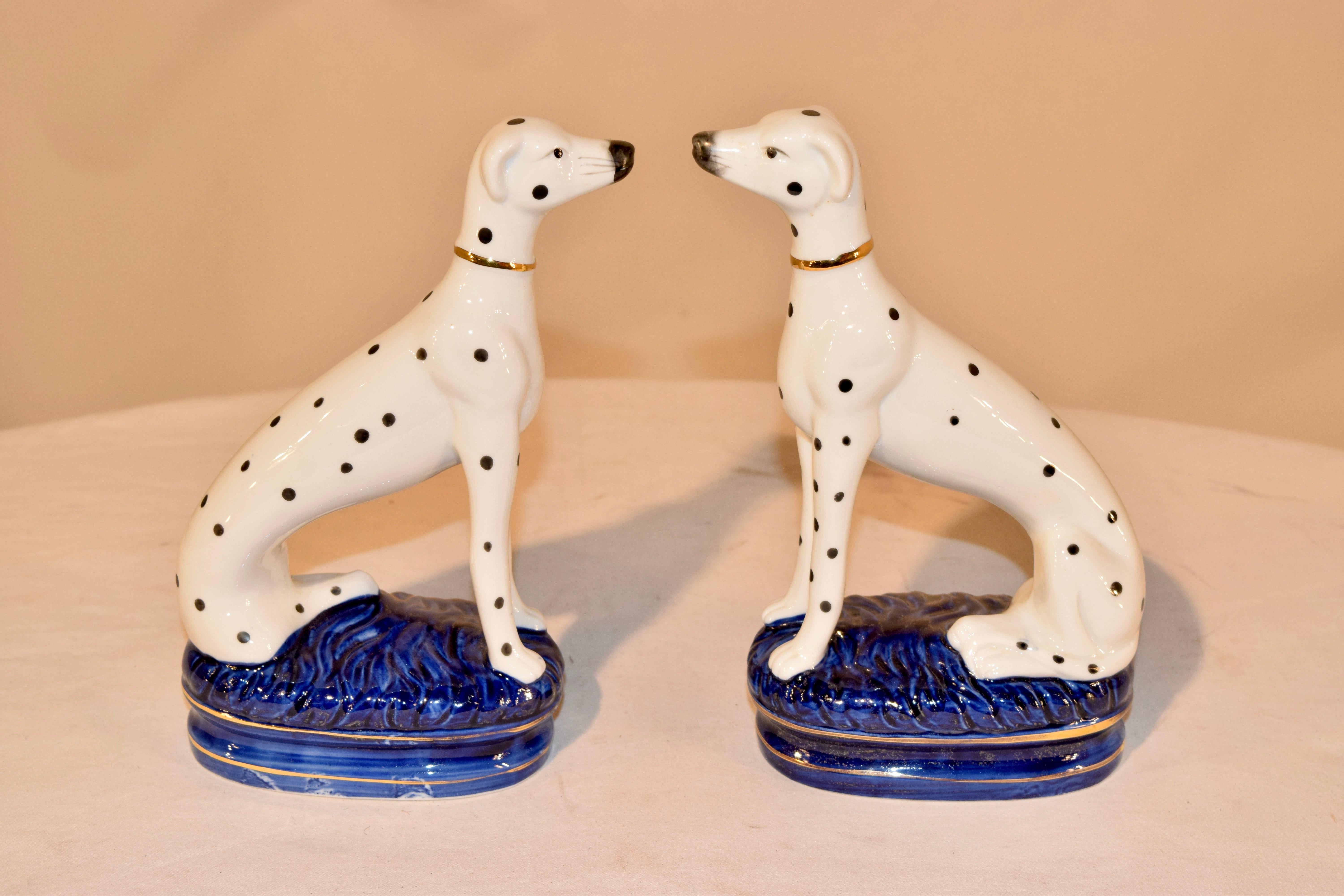 Pair of Staffordshire pottery Dalmatians, circa 1960s. They are a wonderful model and are hand painted in black and white and raised on cobalt blue bases. The dogs have separated front legs.