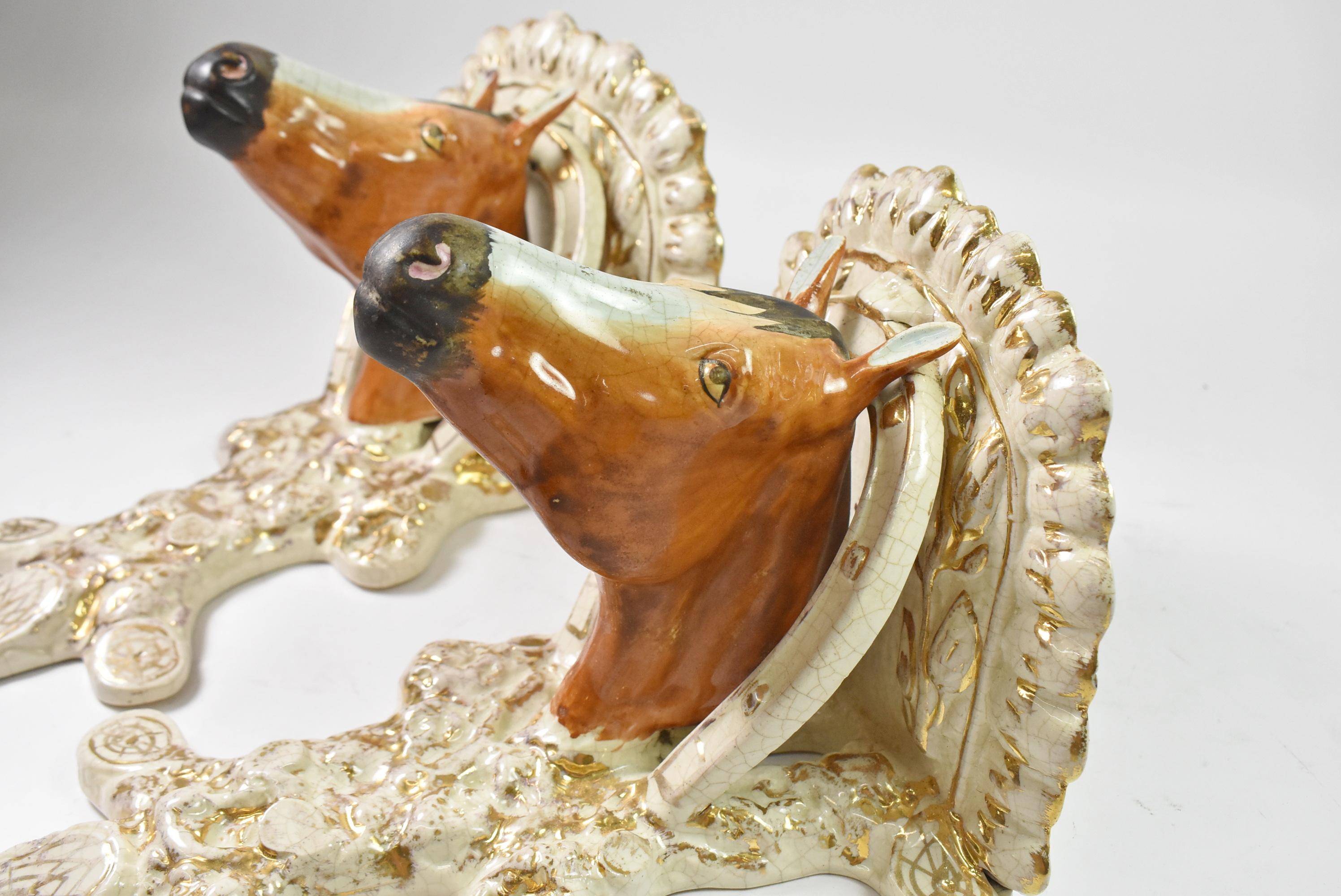 Pair of English Staffordshire horse sconces or wall shelves. Circa 1870, 19th century. Molded forms. Features horse painting lifelike colors. General crazing, minor fritting, as photo'd. Horsehead with horseshoe in cream color with glided