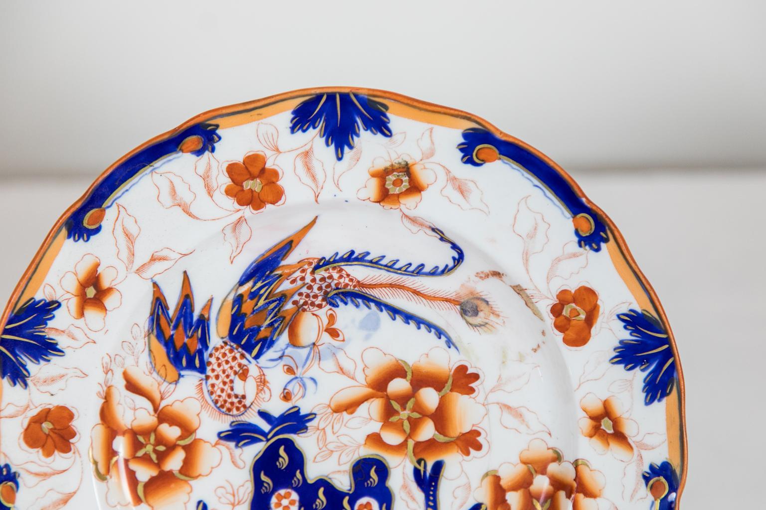This pair of plates is decorated with stylized flowers, leaves, and birds. There are no markings, but the decoration, glaze, and construction style are indicative of a style prevalent in the early to mid-19th century, possibly Coalport.
    