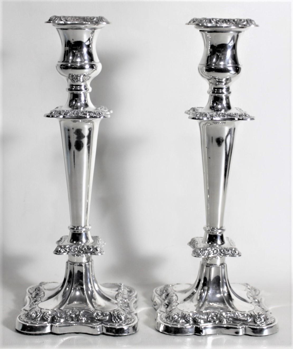 This pair of sterling silver candlesticks were made by Edward Viner of Sheffield England in circa 1950 in an Edwardian style. The candlesticks are composed of sterling silver with weighted bases and have nicely chased floral decoration on the