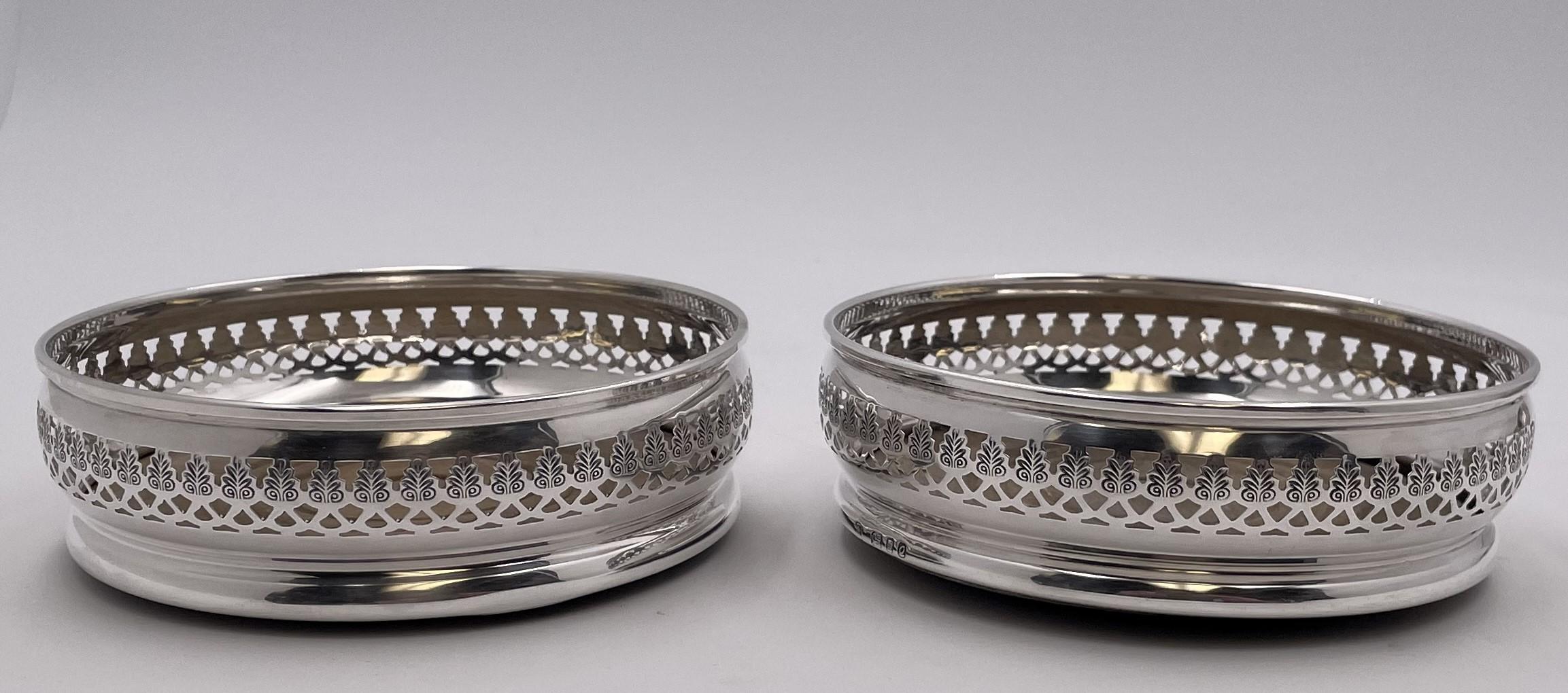 Pair of English sterling silver and wood coasters, made in London in 1969, with pierced geometric motifs. They measure 5 1/2'' in diameter by 1 2/3'' in height and bear hallmarks as shown.

Please feel free to ask us any questions, and please see