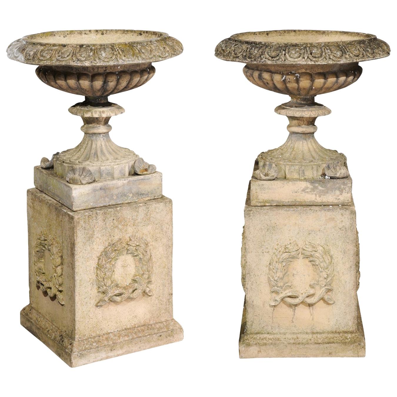 Pair of English Stone Garden Urns on Pedestals with Laurel Wreaths and Gadroons