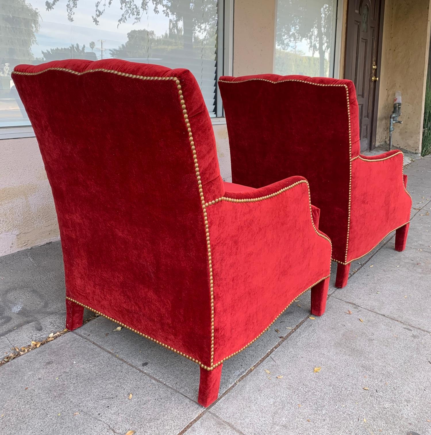 Beautiful pair of English Style armchairs designed and manufactured in the USA, the chairs have tufted backs and nail-head trimming, upholstered in red velvet fabric, newly upholstered and ready to be displayed.
The cushion is
