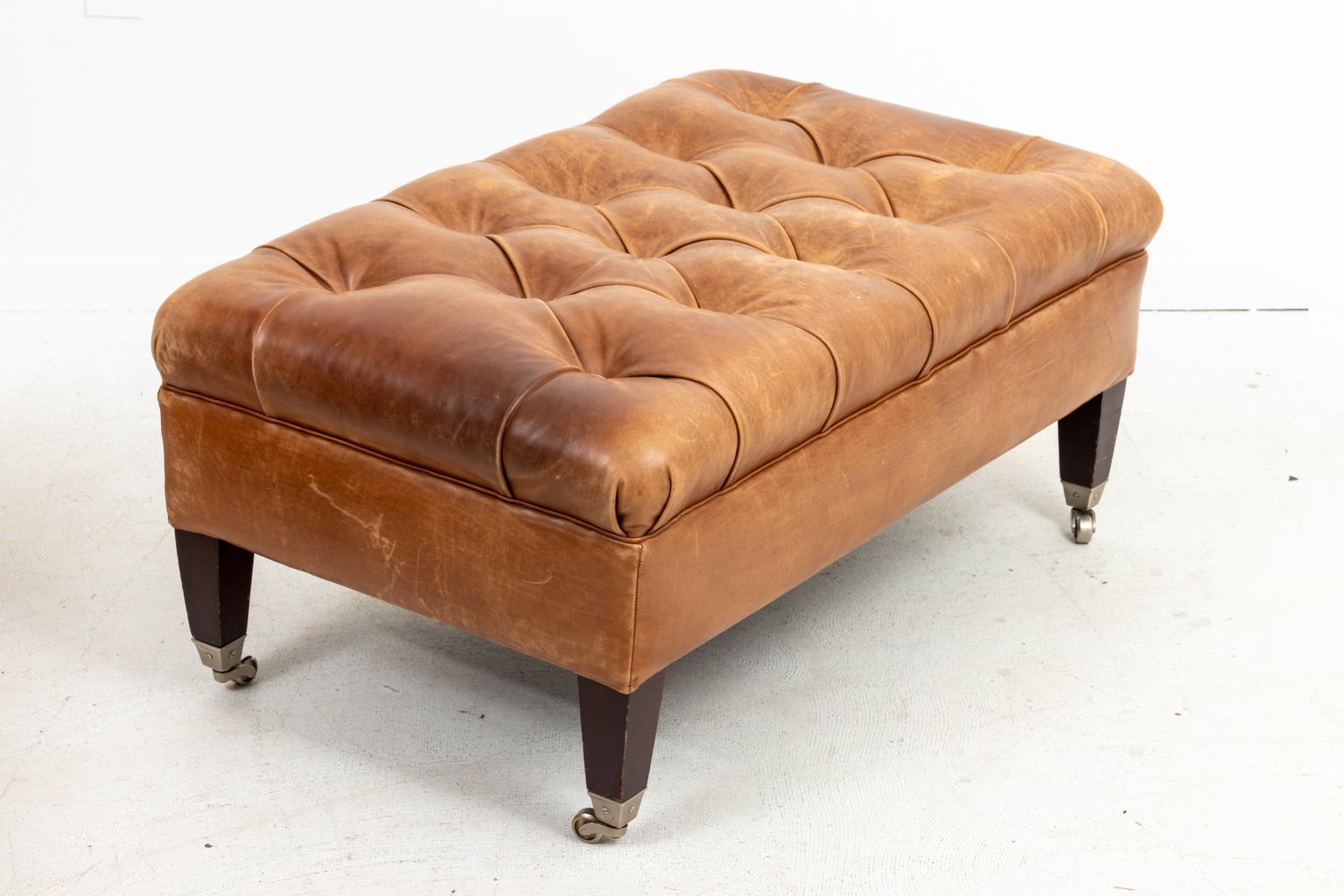 Pair of leather tufted benches with square tapered legs and chromed casters, circa 1960s. Please note of wear consistent with age.