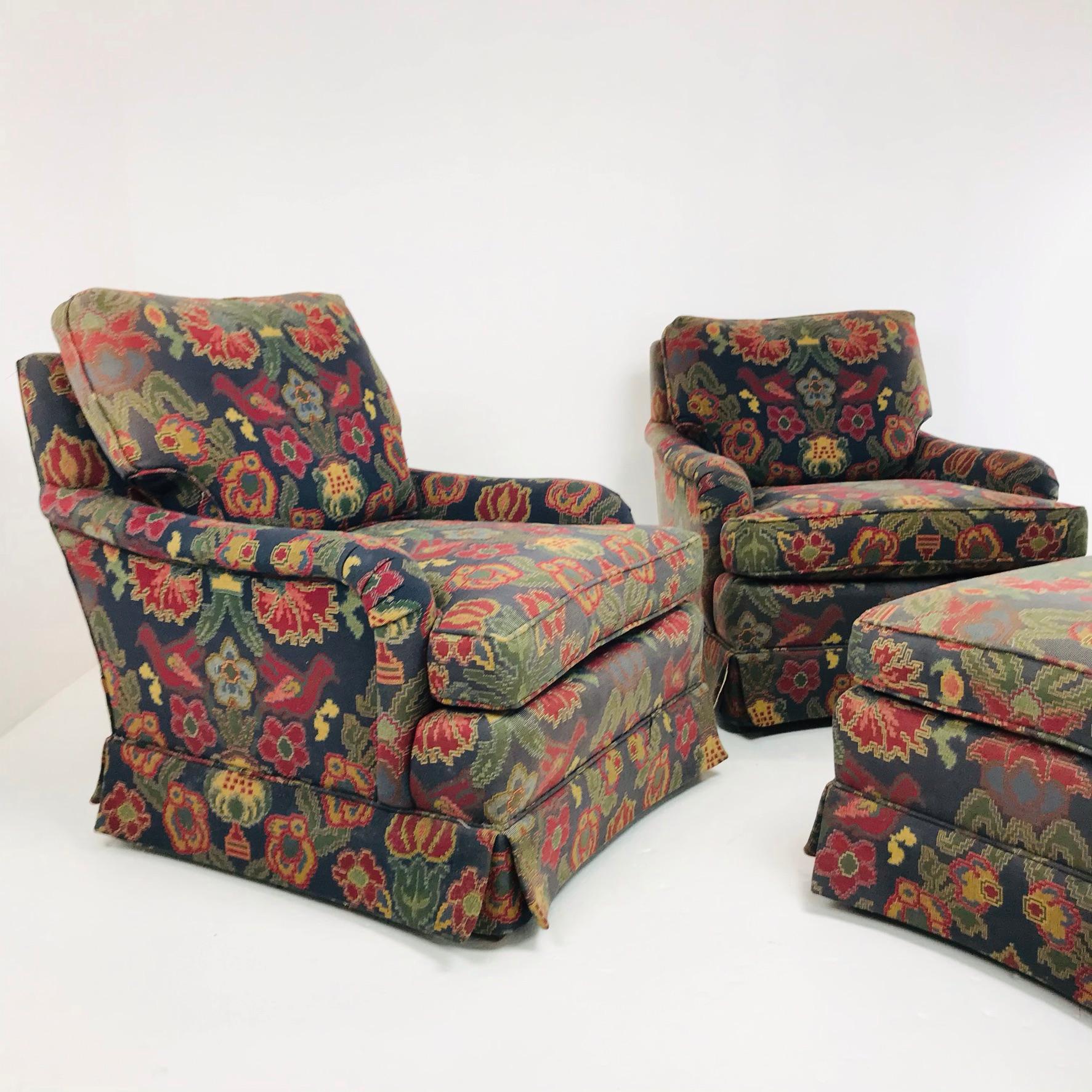 Vintage pair of English style lounge chairs with one ottoman by Baker Furniture Company. Extremely sturdy frames. Fabric is sun faded on one chair and we recommend re-upholstery. Chairs measure: 32