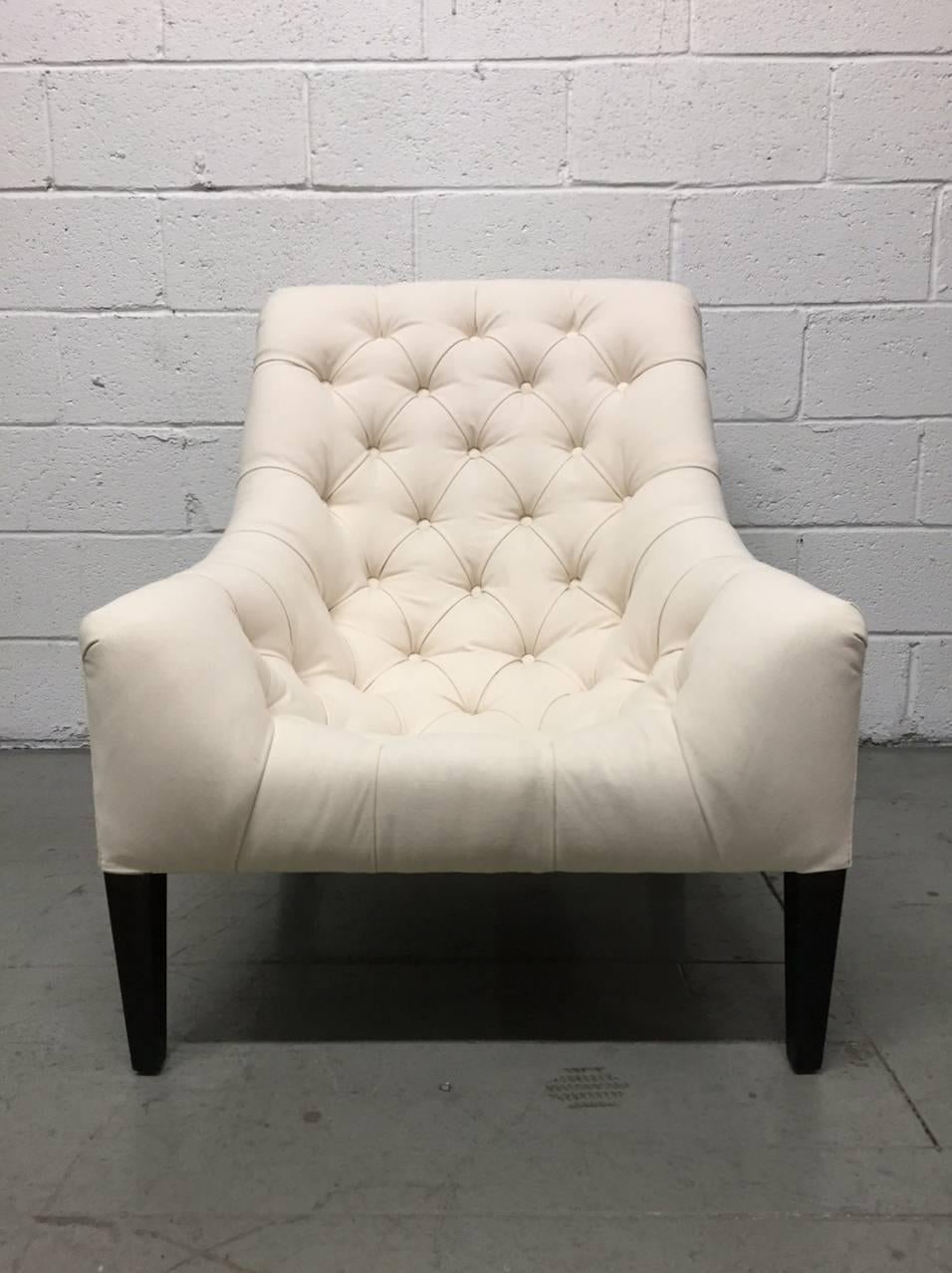 Pair of English tufted upholstered lounge chairs. Has wooden lacquered legs. Chairs are very comfortable Library chair. Upholstered in a linen-blend.
  
