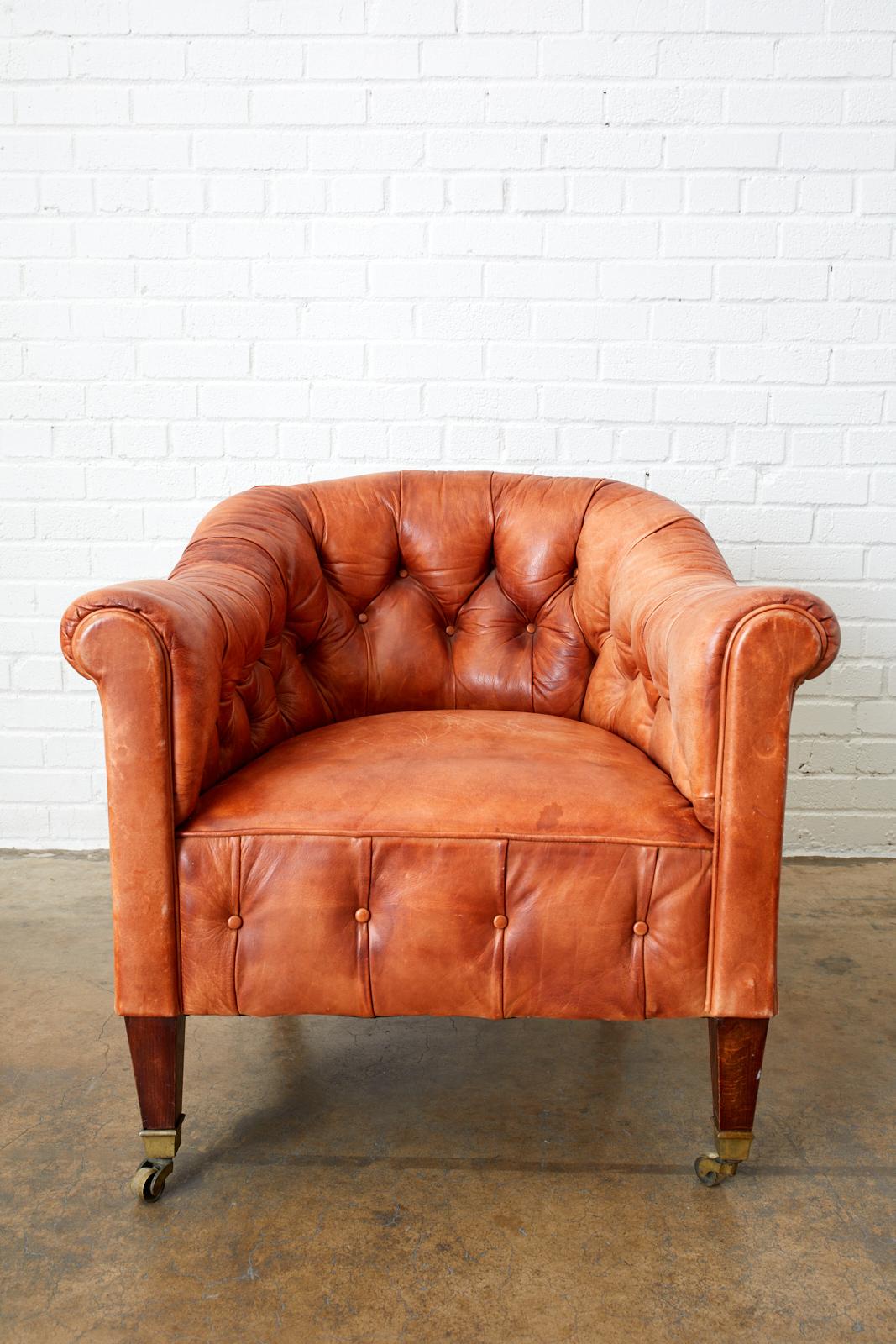 Spectacular pair of English leather Chesterfield style club chairs or tub chairs. Featuring a beautifully aged and faded tufted leather upholstery. Rich, supple cigar leather that has faded into different stages of light saddle color. Large generous