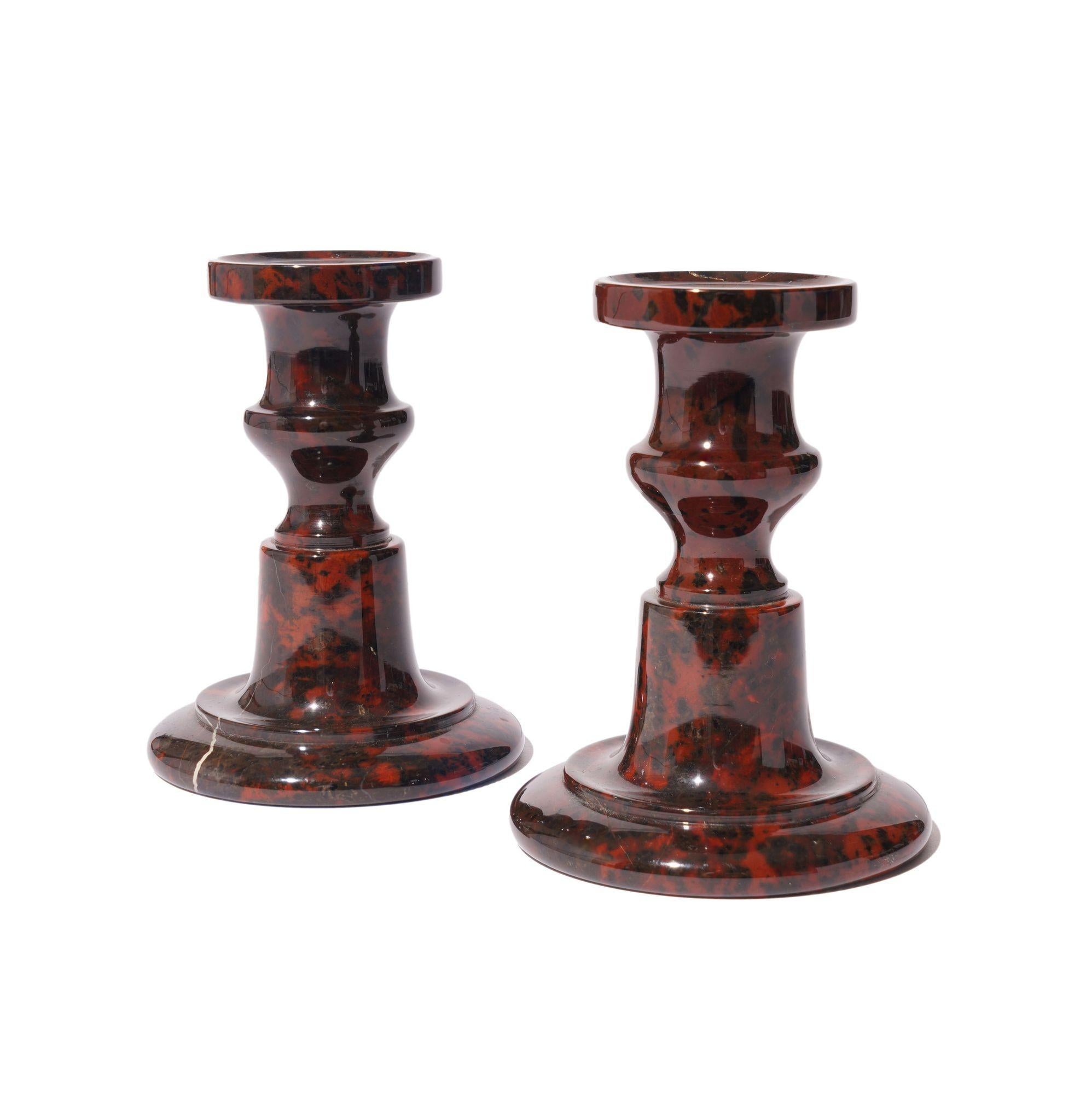 Pair of turned and polished serpentine circular base candlesticks with urn form candle cup on a pedestal with footed base. The underfoot is unpolished.
Cornwall, England, circa 1835.