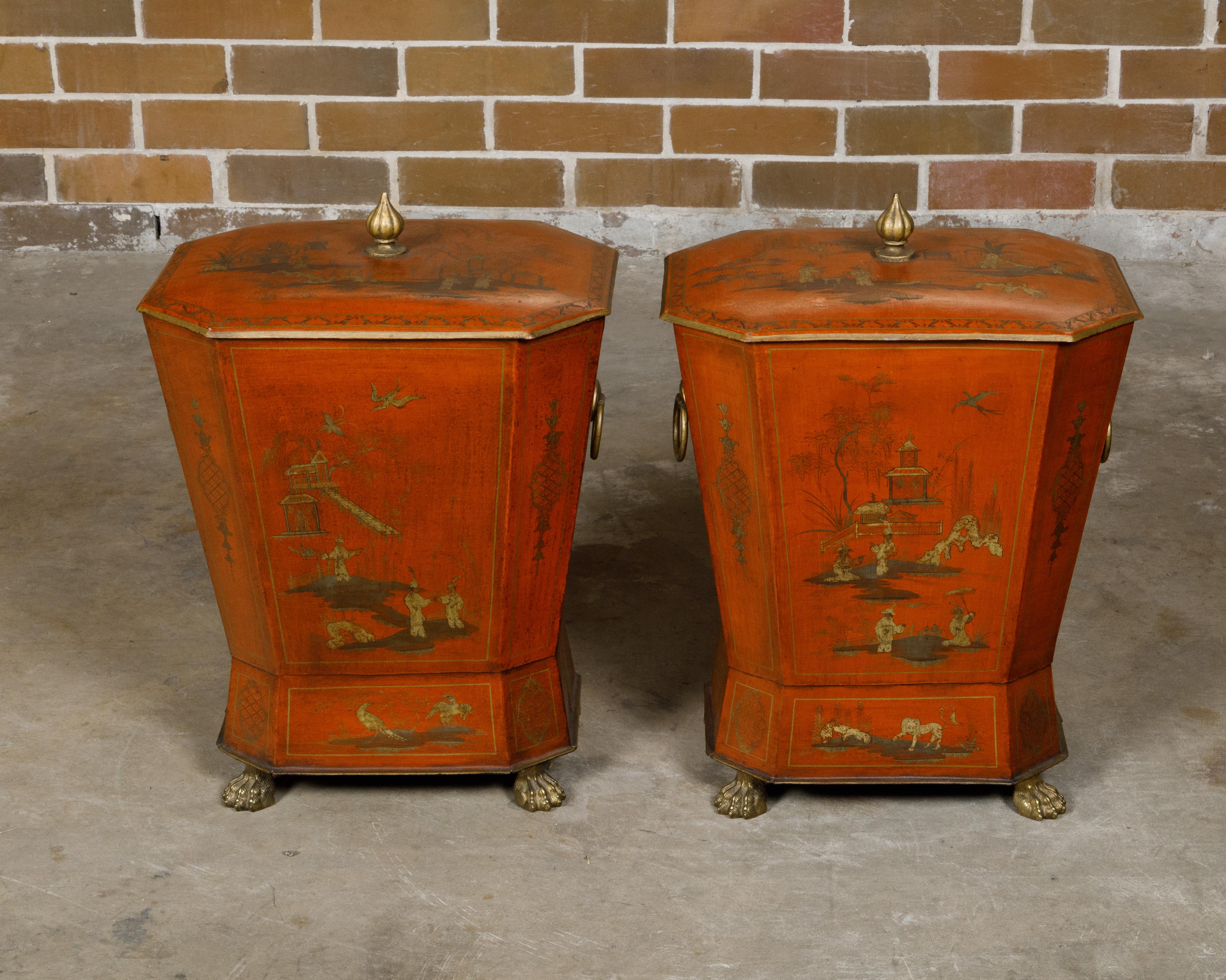 A pair of English Victorian period red lacquered tôle cellarettes from the 19th century with gilded Chinoiserie décor and lion paw feet. This exquisite pair of English Victorian period cellarettes captivates with its vibrant red lacquered finish and