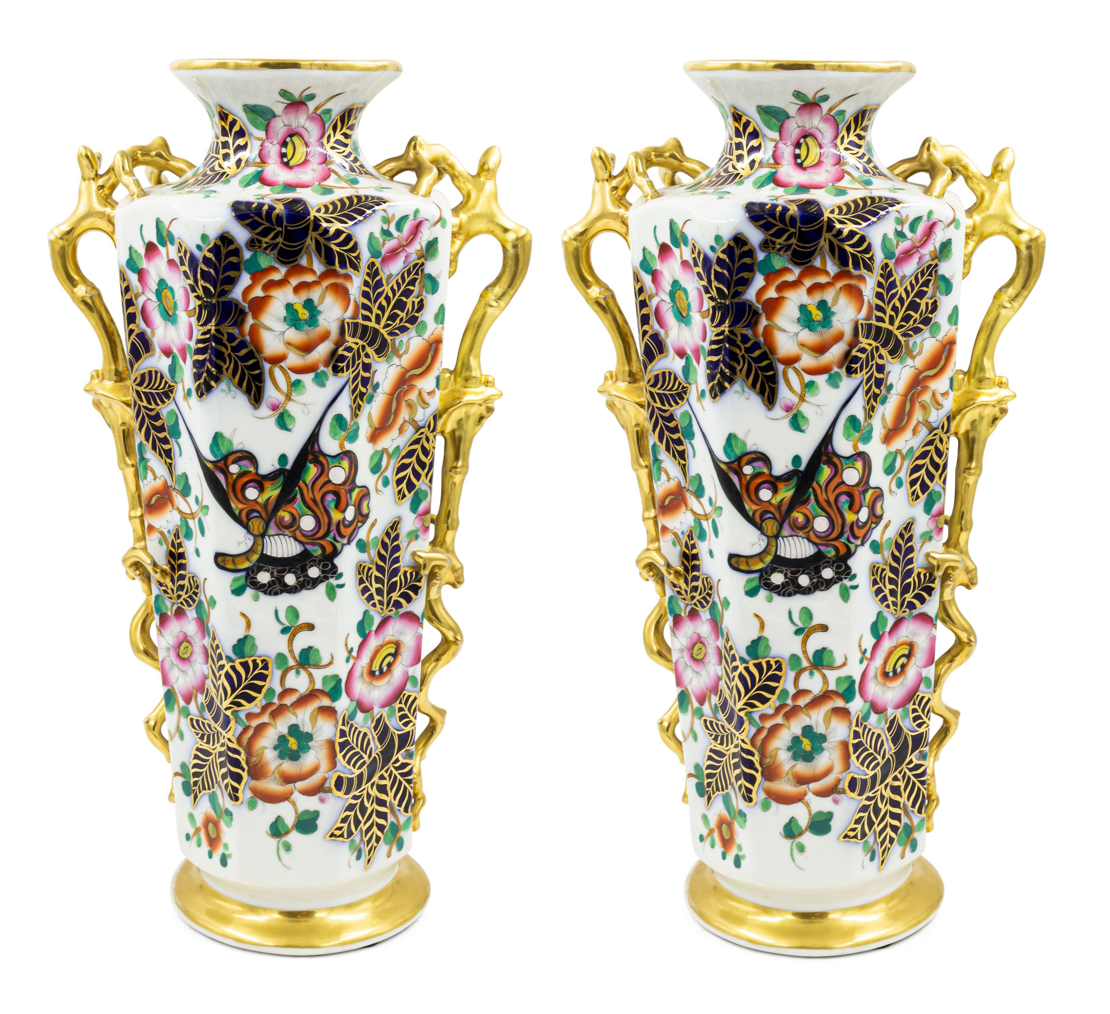Pair of English Victorian (possibly Chelsea) porcelain cobalt blue & white octagonal vases with painted Chinese style figures and trimmed with gilt faux twig handles. (PRICED AS PAIR).
 