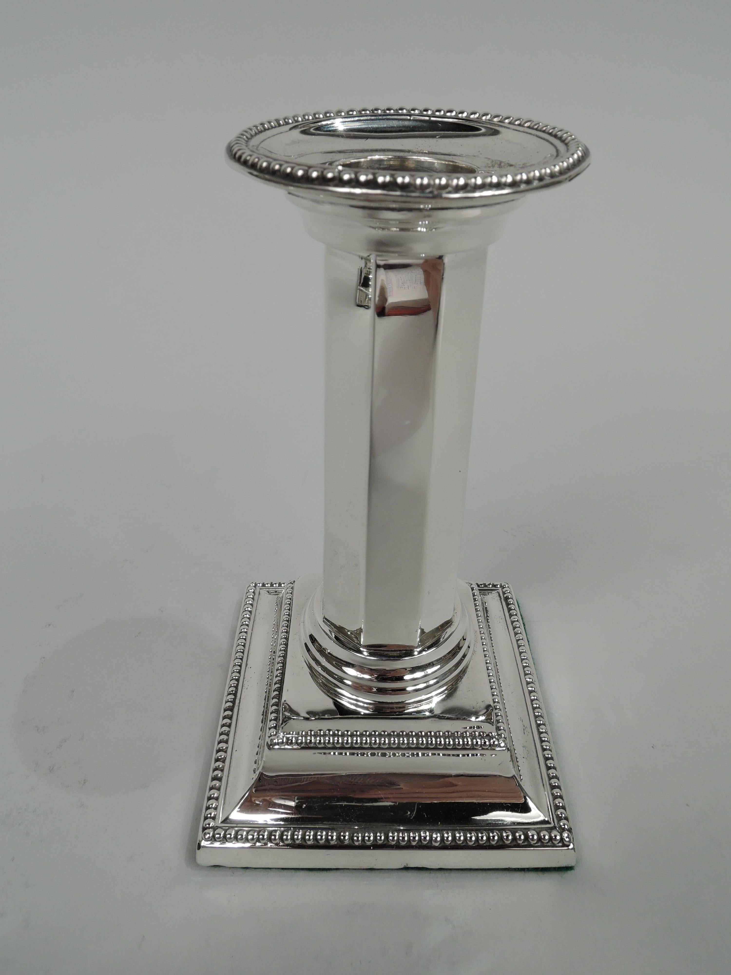 Pair of Victorian Classical sterling silver candlesticks. Made by James Deakin & Sons in Sheffield in 1895. Each: Faceted column on raised square base. Detachable bobeche. Beading. Fully marked. Weighted.