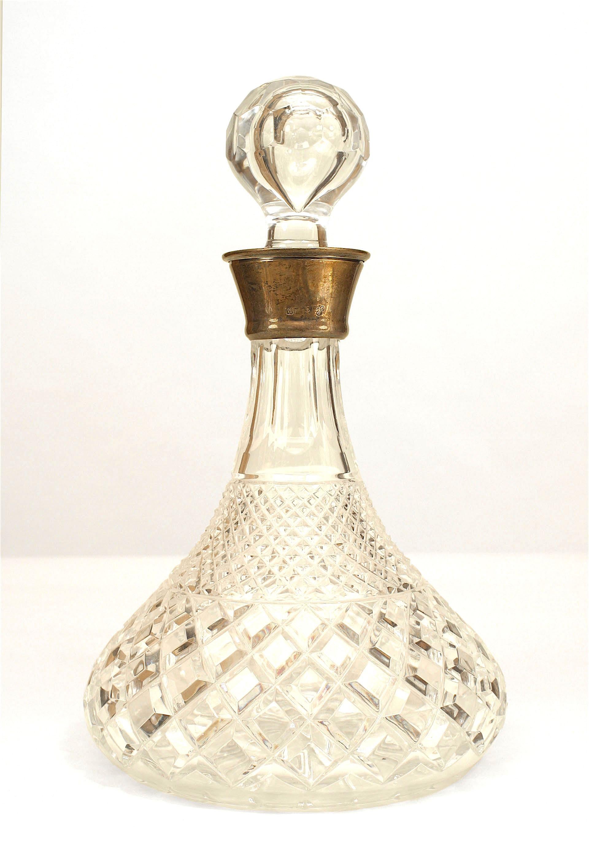 Pair of English Victorian cut crystal decanters with a bulbous base tapering to narrow silver neck holding a ball top cover.