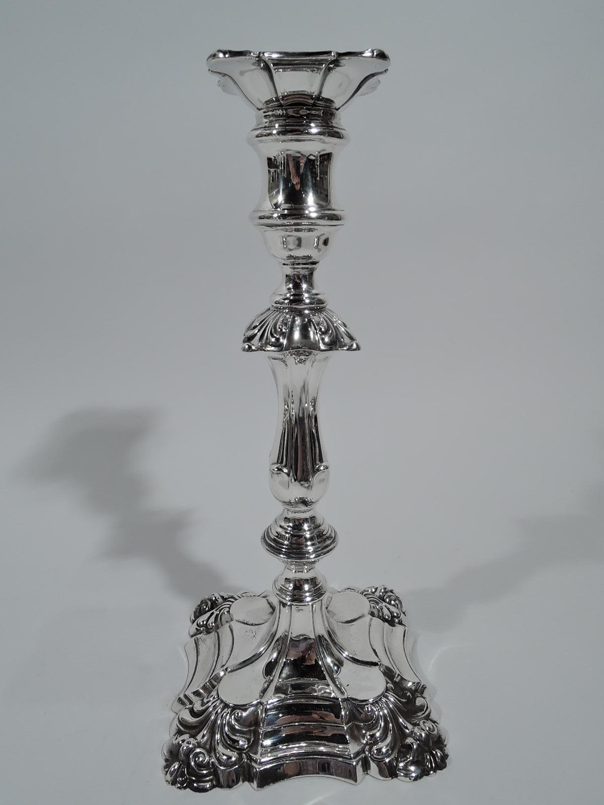 Pair of Victorian Georgian sterling silver candlesticks. Made by Thomas Bradbury of Sheffield in 1894. Fluted and knopped baluster shaft with leaf flange. Spool socket with detachable square bobeche. Foot raised and stepped with leaf-and-scroll