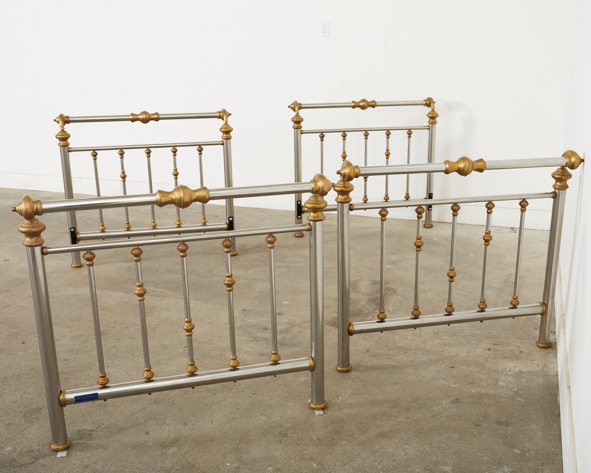 Matching pair of English Victorian style twin sleigh beds crafted from patinated brass and polished steel. The set includes two headboards and two footboards ready to bolt to twin bed frames. The beds include necessary hardware to bolt to frames.