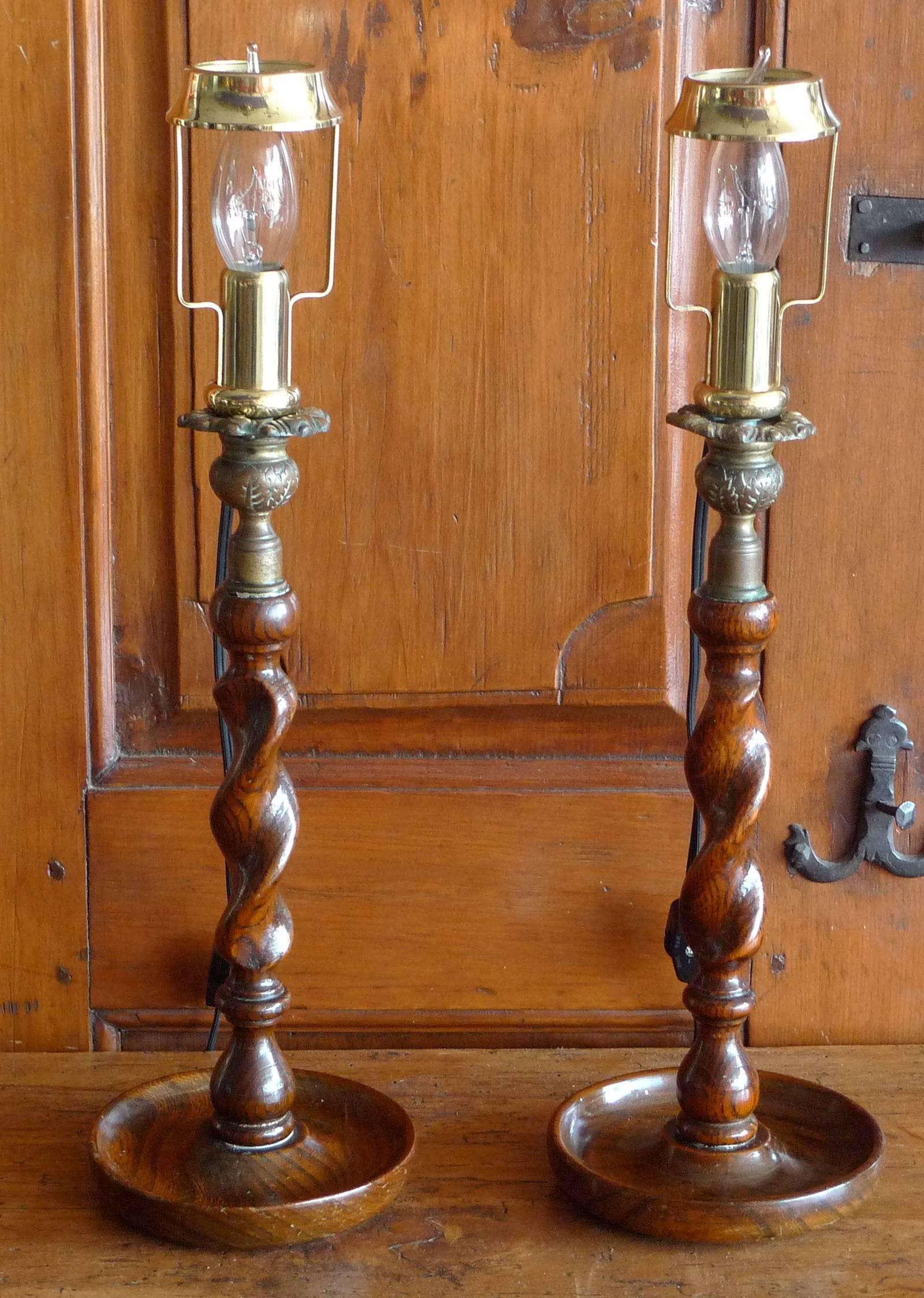 Pair of English 19th century stained walnut barley twist table lamps with brass light holders.