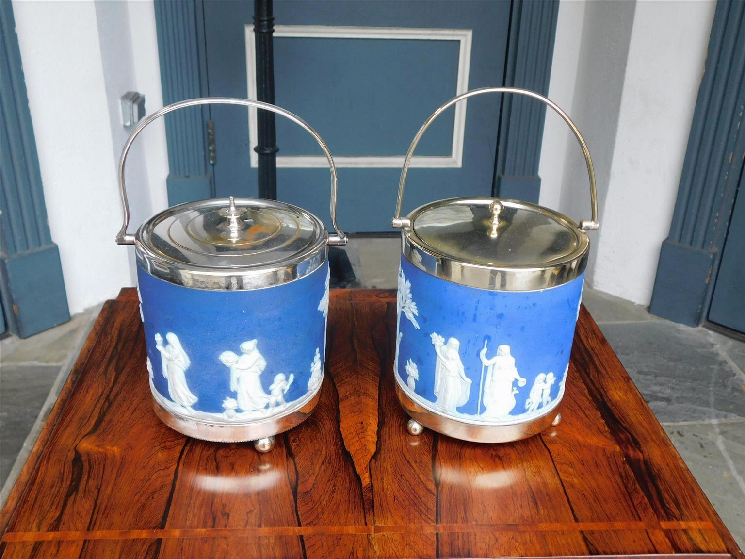 Pair of English Wedgewood figural and foliage silver plate biscuit barrels with original folding handles and removable lids. 19th Century.