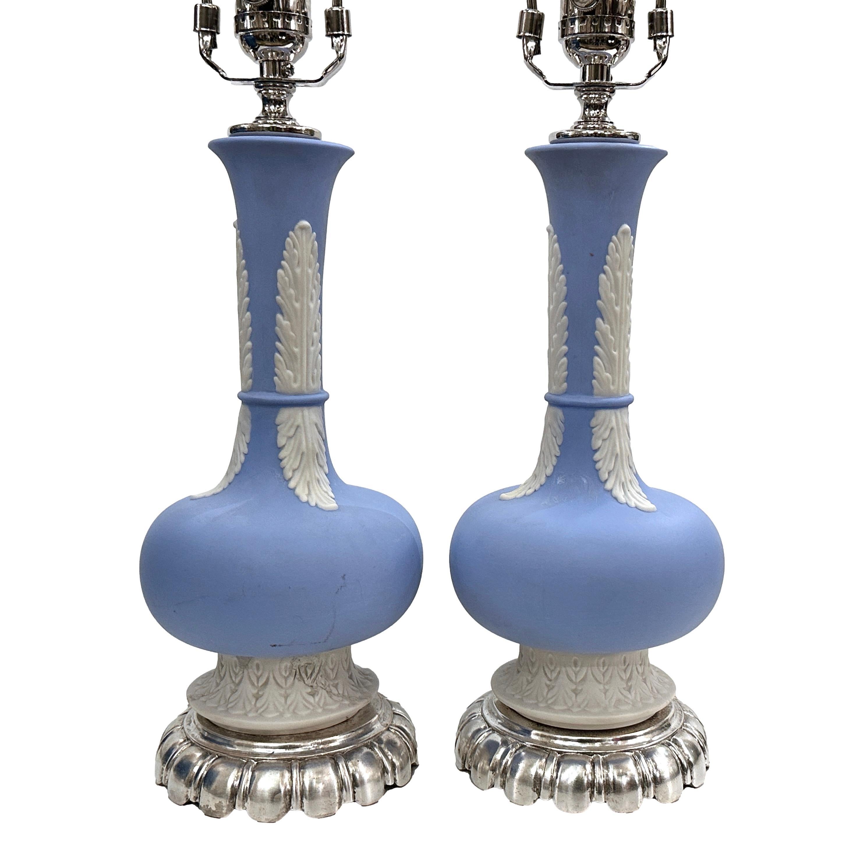 A pair of circa 1920's English Wedgwood lamps with silvered bases.

Measurements:
Height of body: 13
