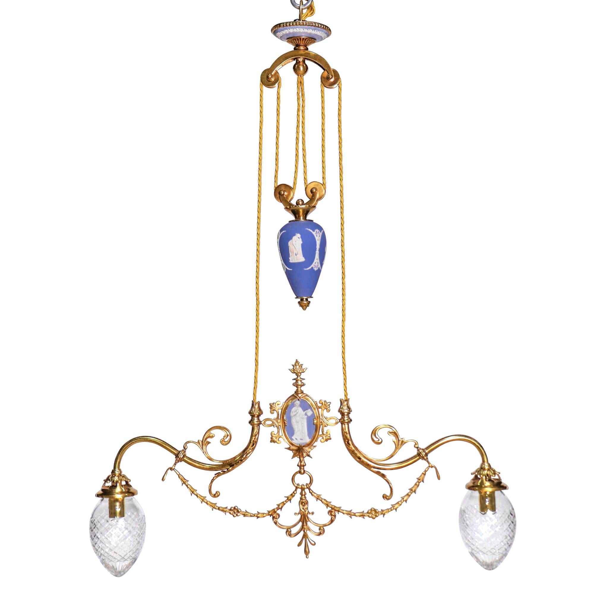 Pair of English Barbell Chandeliers by Wedgwood with blue jasperware, chiseled bronze accents and two bulbs covered by decorated clear glass egg shape diffusers.

Each chandelier consists of a canopy, egg-shaped urn and two arms, adorned with a
