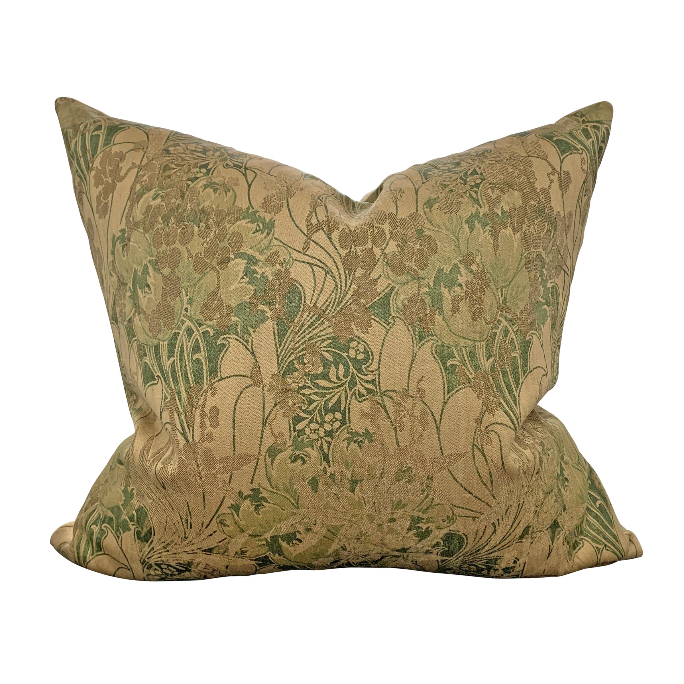 A pair of wonderful pillows made from late 19th-early 20th century English William Morris woven panels with elaborate large tulips and other flowers all woven in varying shades of green and olive. Backed with new silk panels, and filled with down.