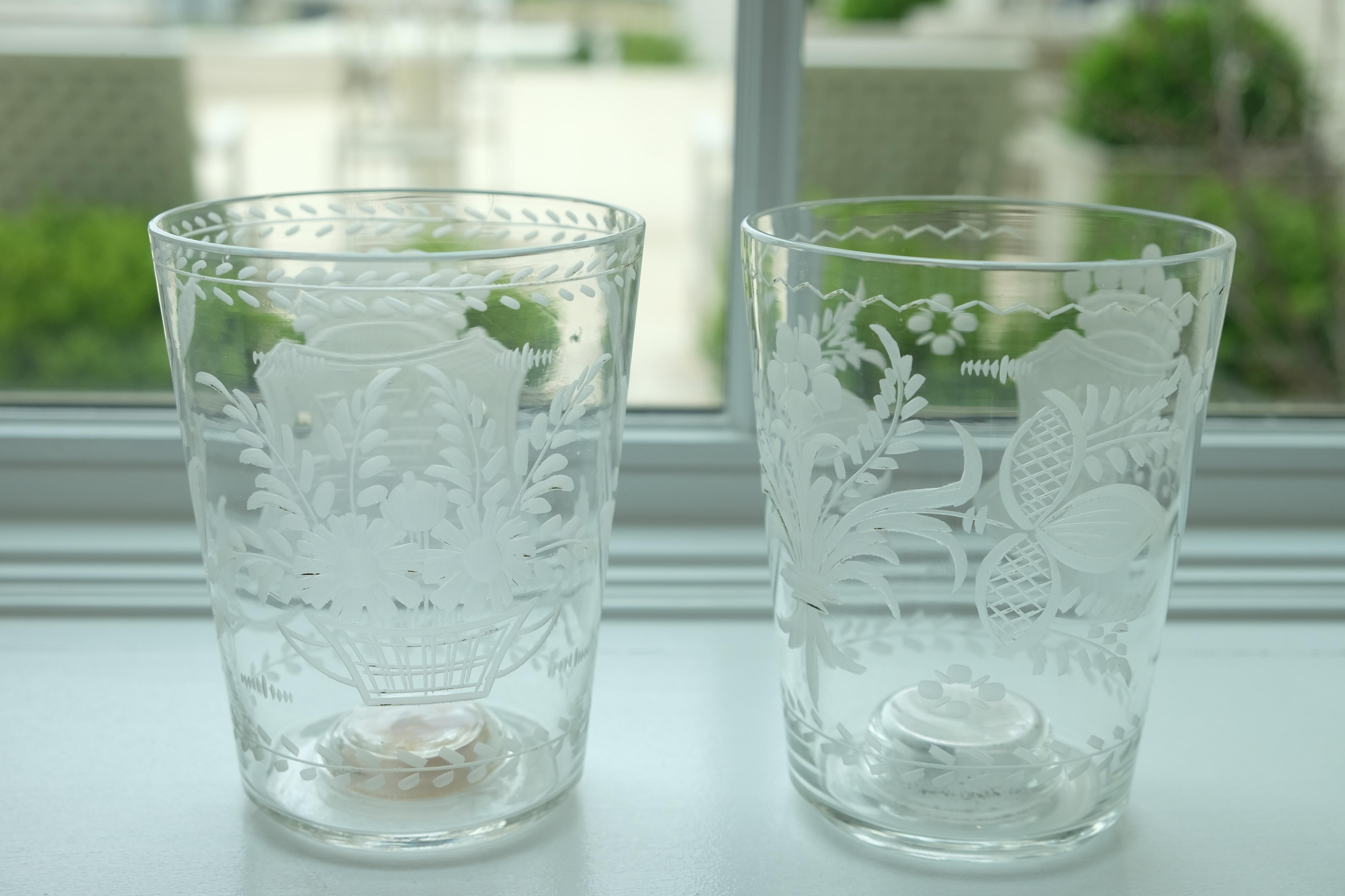 Pair of engraved armorial beakers. The first is a 