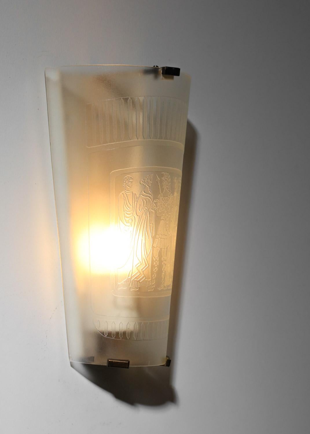 Italian wall lamps from the 1960s. Solid brass structure with a patina finish, curved frosted glass shade decorated with figures from antiquity. Very good vintage condition, slight signs of age and use (see photos). We recommend E14 LED bulbs.