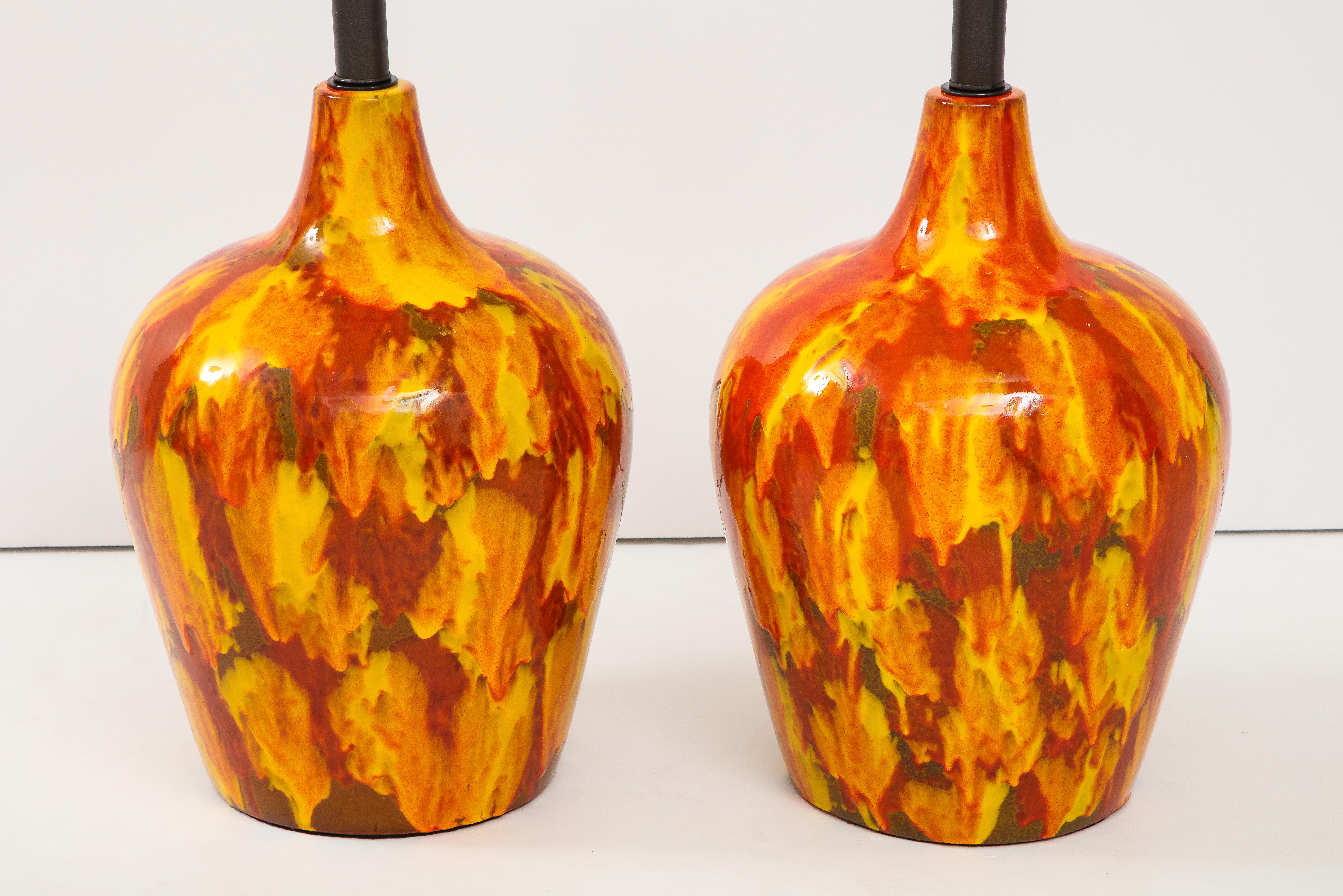 Wonderful pair of enormous ceramic lamps with a striking glazed finish.
The lamps have been newly rewired with bronzed finished adjustable double clusters
that take standard size light bulbs.
The height to the Top of the ceramic is 21