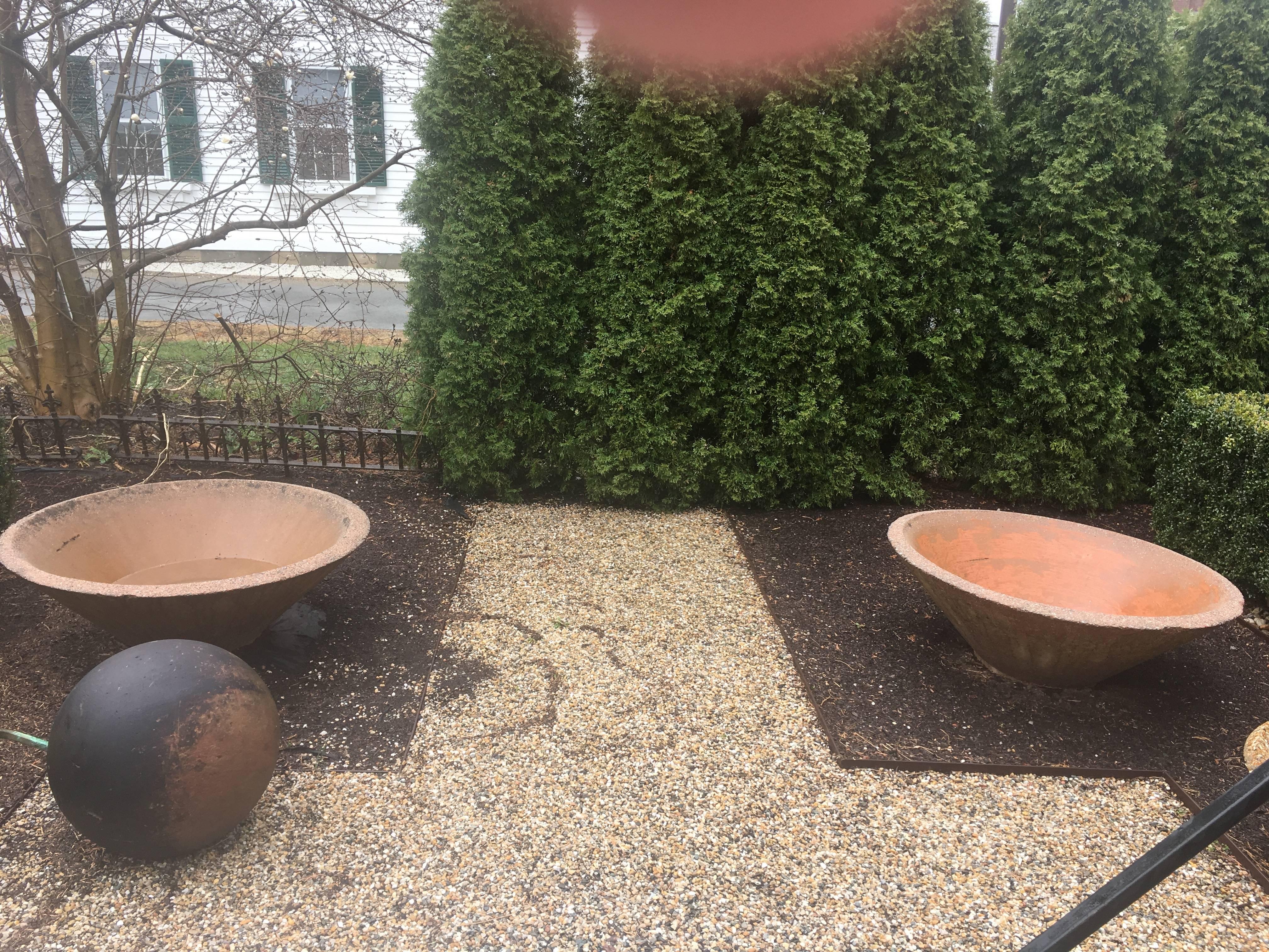 These large canted bowl are just sensational! Made from a pinkish cast stone with heavy grey pebble aggregate (visible on the rims), these will accommodate even the largest and most profuse plantings. The outsides have faded to a lighter pinky-green