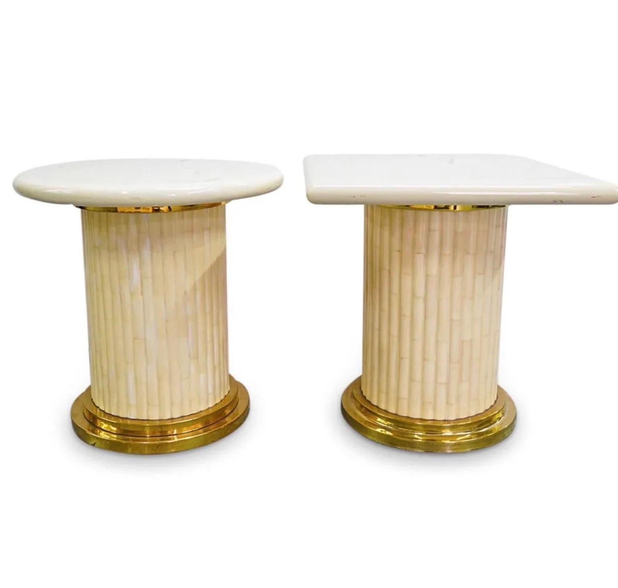 Two side table by Enrique Garcia-one crowned with a square top, one with a round top-each composed of ivory toned acrylic and embellished with gilt brass trimmings beneath the platform and at the foot. Tag on underside: 