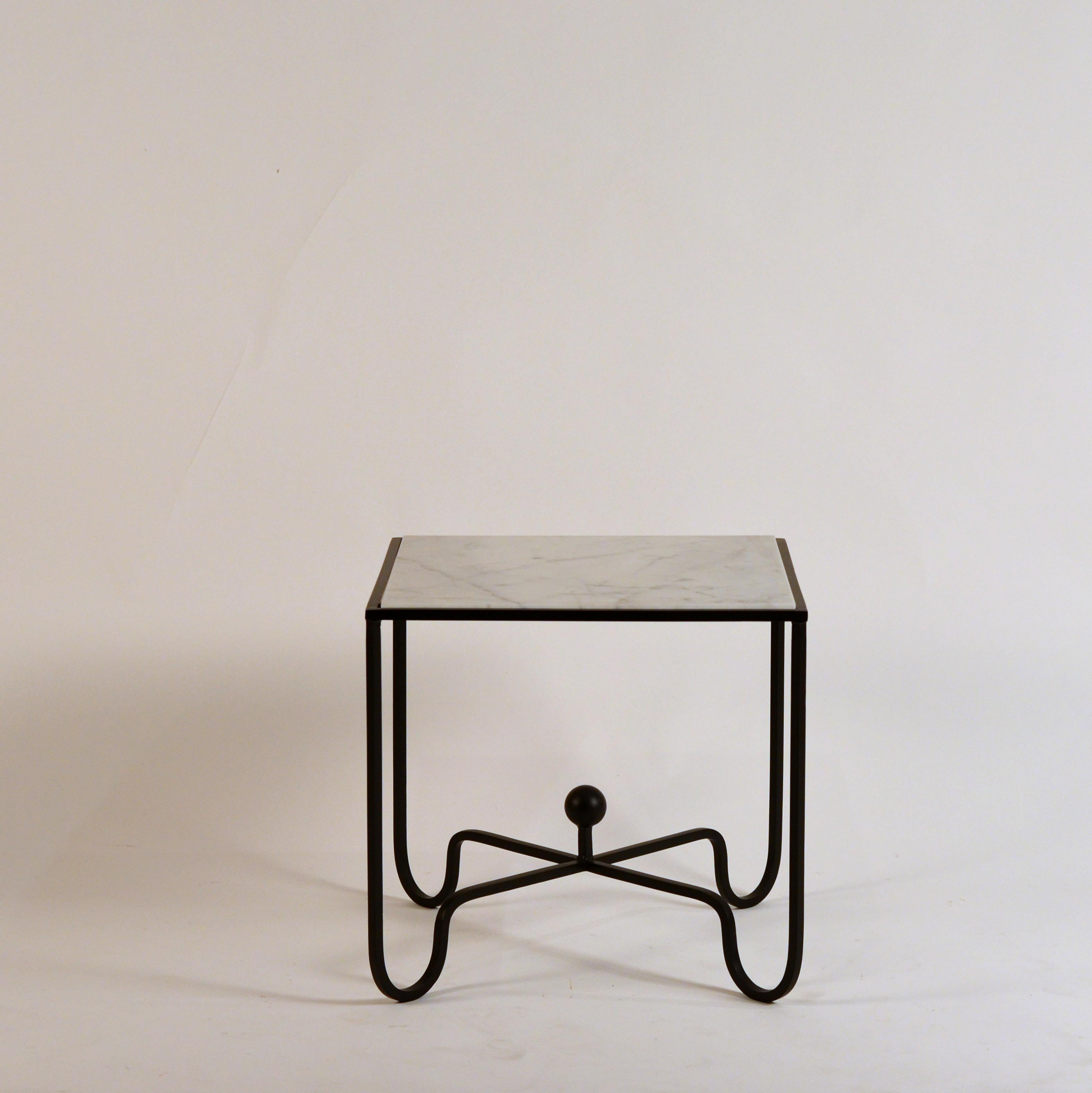 Chic pair of wrought Iron and marble 'Entretoise' side tables by Design Frères. Matte black wrought iron bases with honed white veined marble tops.