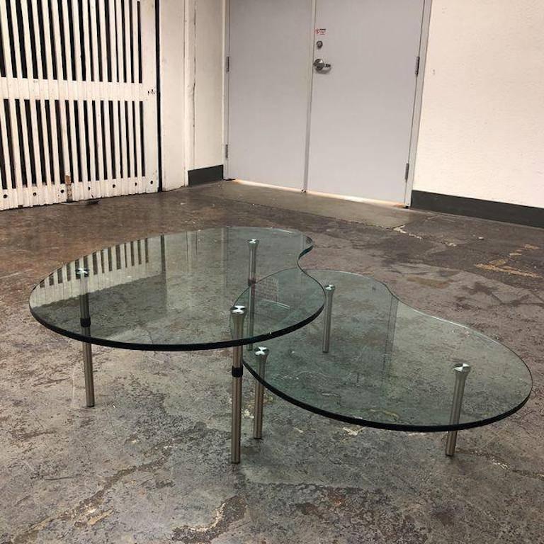 A Zanotta Ambo coffee. Table. The nesting tables were designed by Enzo Mari in 1987. Sleek and contemporary! The transparent glass and stainless steel legs exude a sophisticated presence that can be just as functional as eye-catching for you and