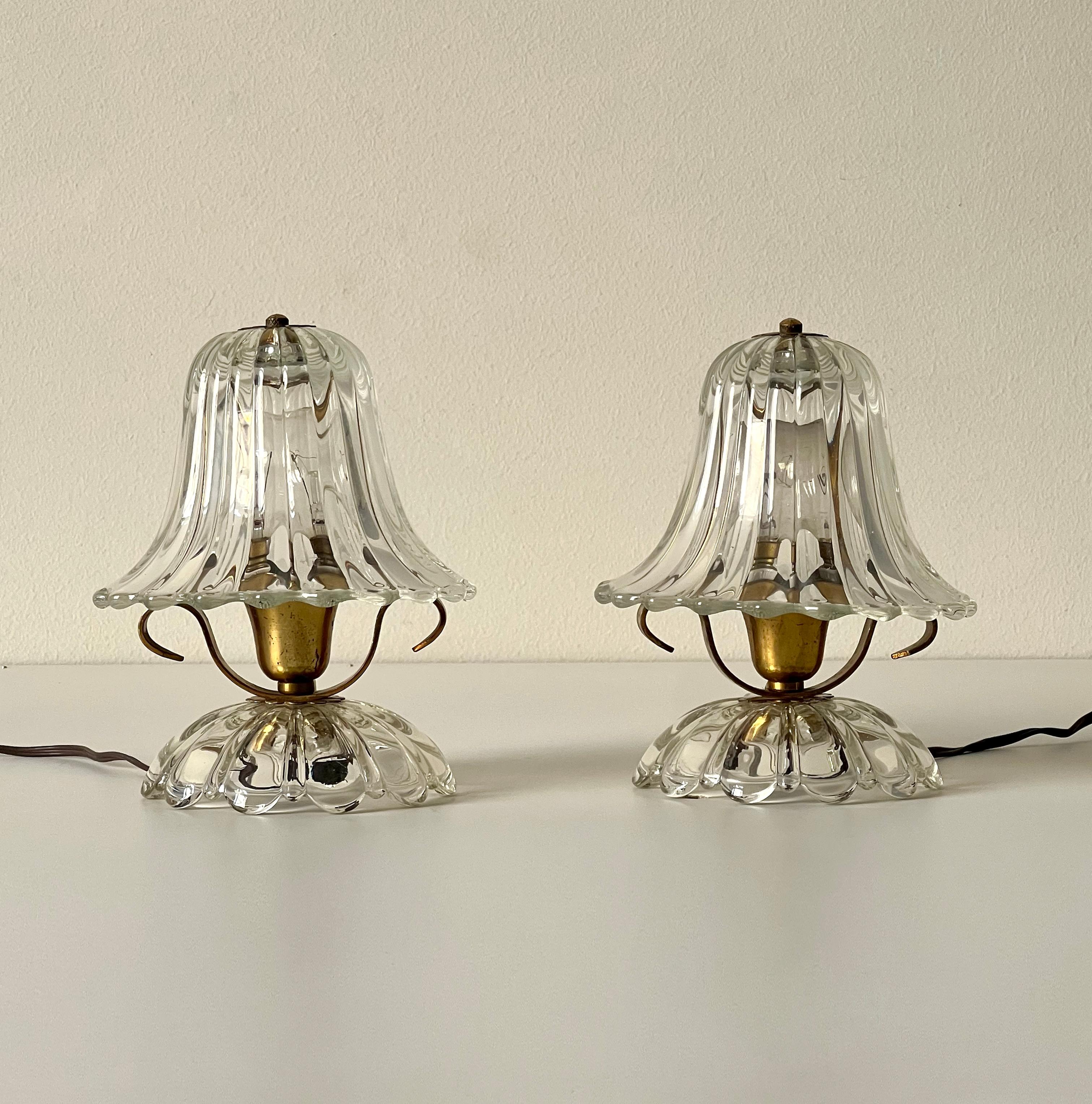 Pair of Ercole Barovier Murano glass and brass table lamps, Italy 1940s.

This is a pair of exquisite table lamps crafted in Italy during the 1940s by the renowned glassmaking company Barovier & Toso. Each lamp features a finely detailed brass